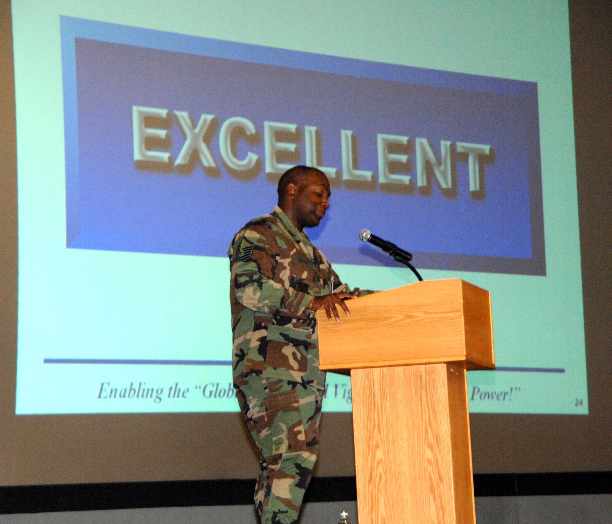 A member of the Air Mobility Command’s Inspector General team announces an "Excellent" rating during the 615th Contingency Response Wing’s Operation Readiness Inspection out-brief. The wing earned an overall “Excellent” rating. (U.S. Air Force photo/Nan Wylie)