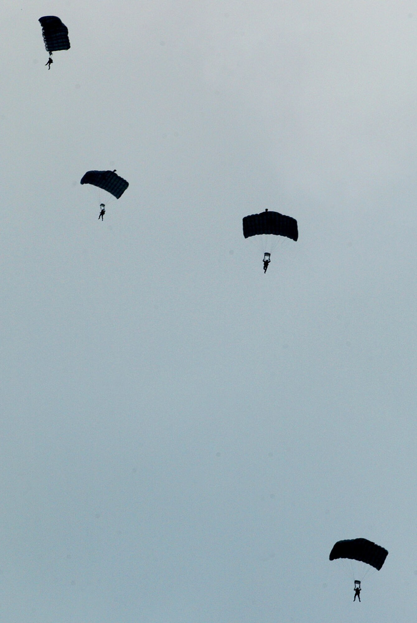 Pararescuemen conduct a parachute drop Oct. 19 on Kadena Air Base, Japan. The Airmen train to maintain proficiency for the defense of Japan and to meet U.S. obligations. The pararescuemen are capable of conducting search-and-rescue missions under most conditions and have saved the lives of both U.S. military and Okinawans. (U.S. Air Force photo/Tech. Sgt. Reynaldo Ramon) 
