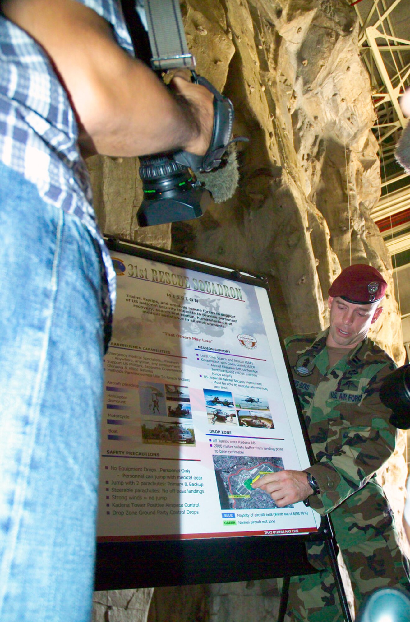 A member of the 31st Rescue Squadron explains the capabilities of pararescuemen to members of the Japanese media before a proficiency paradrop Oct. 19 at Kadena Air Base, Japan. More than 20 media members attended the briefing about the airborne operation and observed the drop. (U.S. Air Force photo/Scott Hallford)
