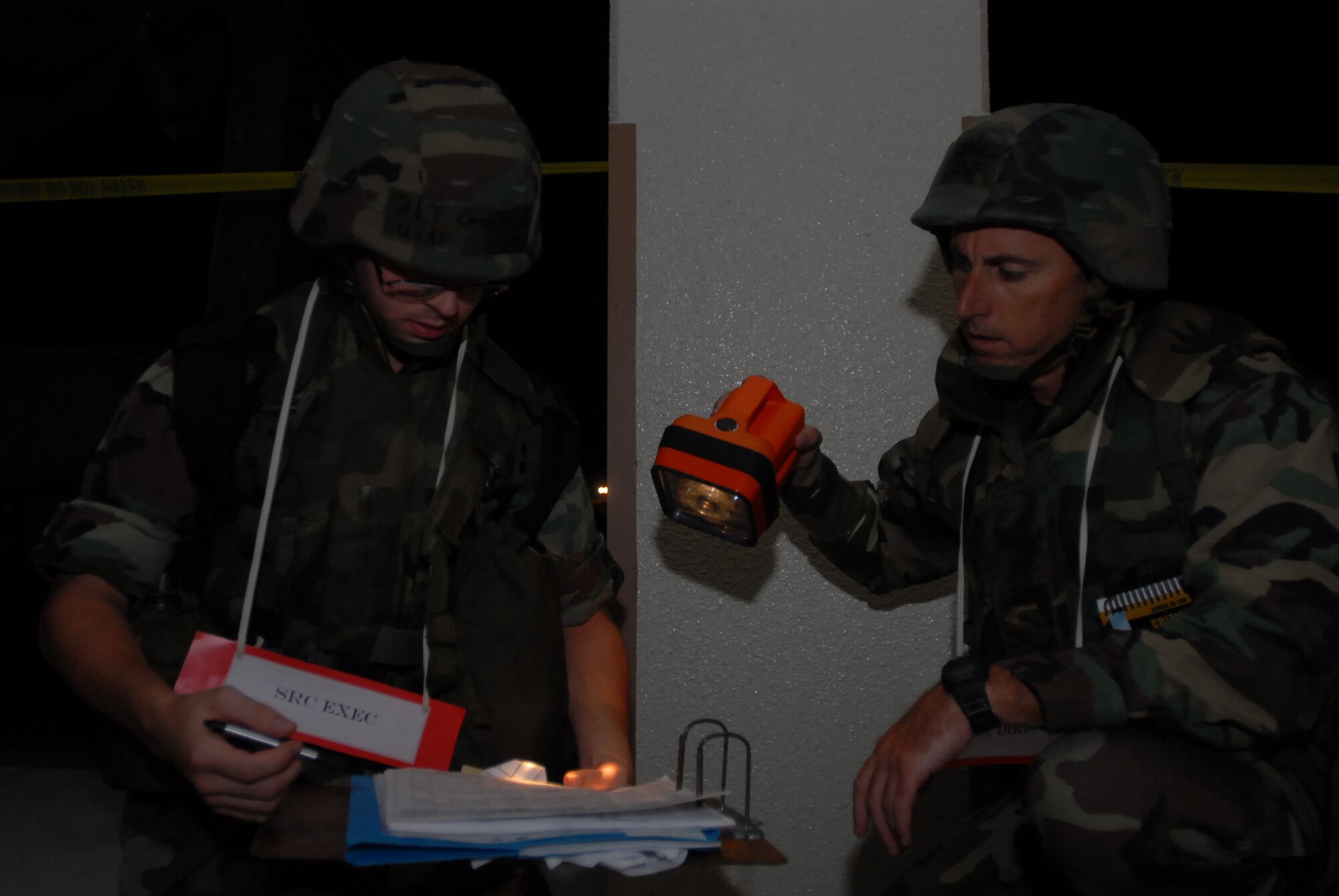 Second Lt. Corey Erickson, 18 Communications Squadron, and Lt. Col. Steven Kennedy, 18th Comptroller Squadron, account for personnel after their facility was evacuated during the Local Operational Readiness Exercise at Kadena Air Base, Japan, Oct. 24, 2007.  The Airmen are supporting training missions based on real-world scenarios as part of Local Operational Readiness Exercise Beverly High 08-1. (U.S. Air Force photo/Senior Airman Darnell T. Cannady)