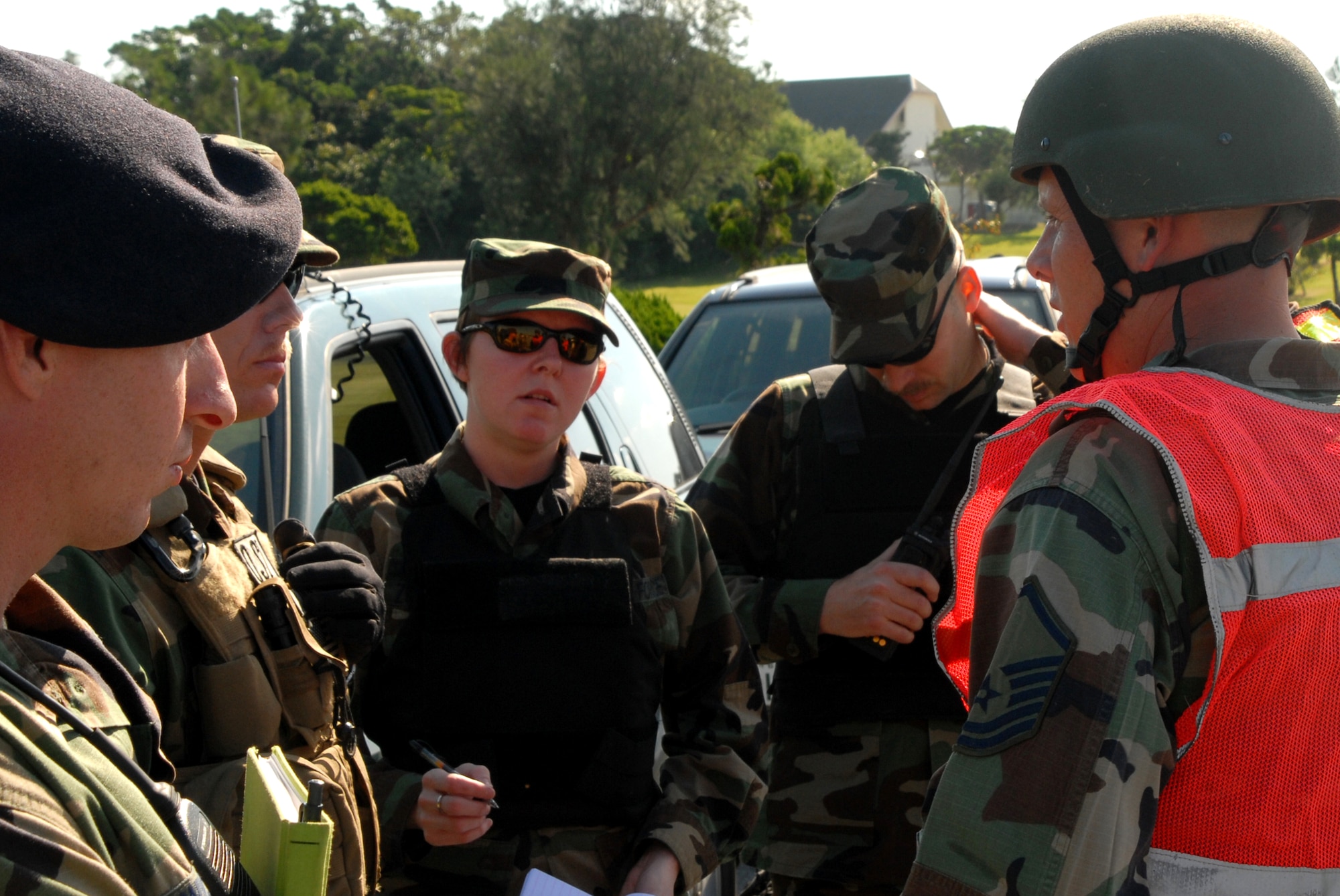 Air Force Office of Special Investigation agents get a briefing by the 18th Security Forces on scene commander during the Local Operational Readiness Exercise at Kadena Air Base, Japan, Oct. 23, 2007. In this scenario base agencies responded to a simulated car bomb.  (U.S. Air Force photo/Airman 1st Class Ryan Ivacic)