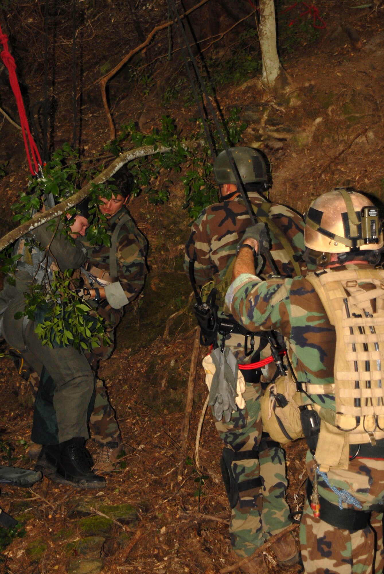 Two PJ’s from the 31st Rescue Squadron lower 1st Lt. Alan “Hawk” Schulenberg, 44th Fighter Squadron, from a tree while another PJ grabs the injured pilot and eases him to the ground during an exercise on proper life saving procedures at Kadena Air Base, Japan, Oct. 23, 2007. In the exercise PJ’s practiced recovering a pilot who ejected from his aircraft and was stuck in the jungle with injures. The scenario was part of the Local Operational Readiness Exercise Beverly High 08-1.  (U.S. Air Force photo/Airman 1st Class Ryan Ivacic)