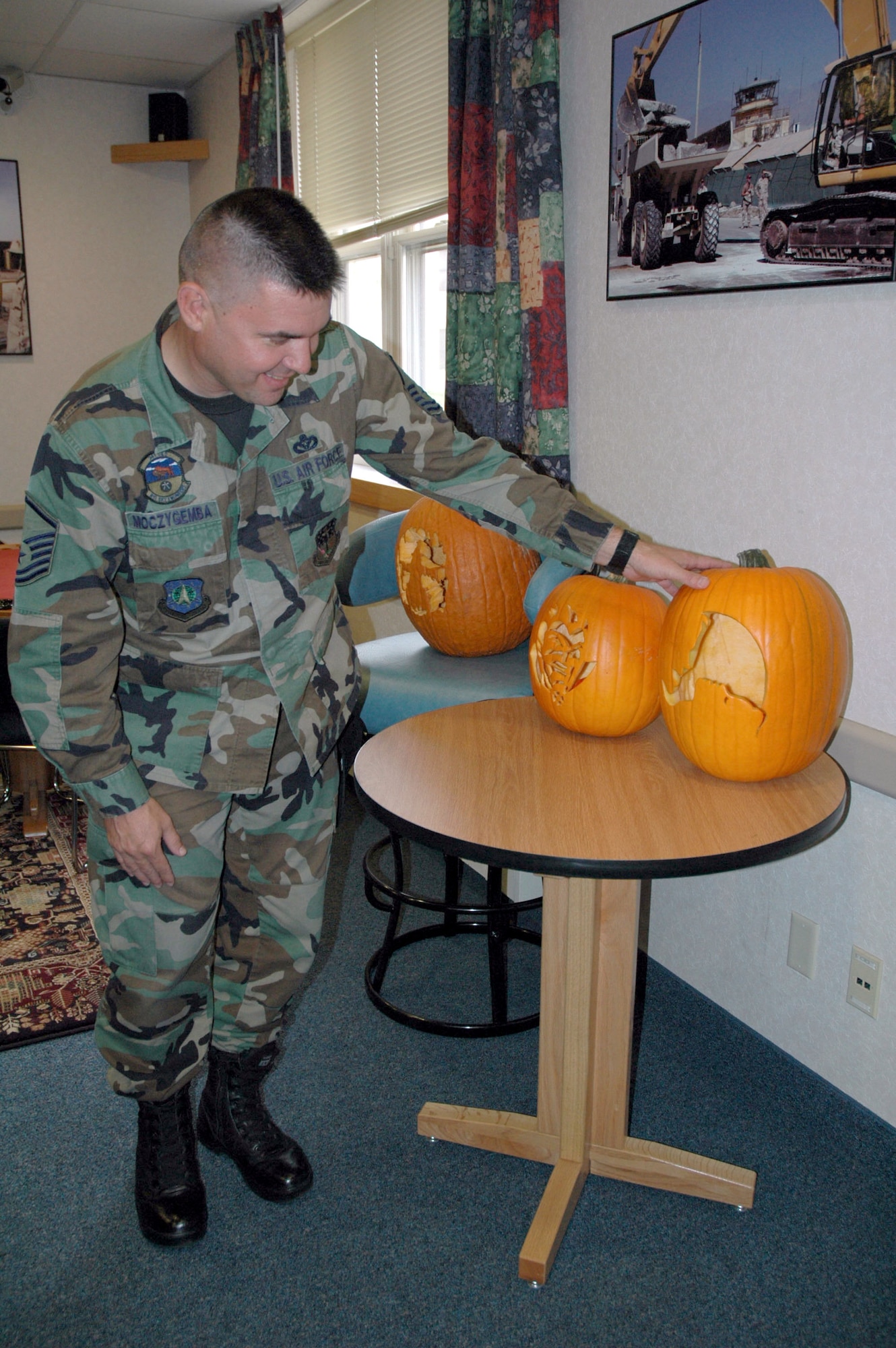 Master Sgt. Albert Moczygemba, 341st Civil Engineer Squadron unaccompanied housing manager, checks out some of the pumpkins entered in a pumpkin carving contest at the 341st Logistics Readiness Squadron and 341st Civil Engineer Squadron dormitory Oct. 19. Airman 1st Class Dayne Bertrand, 341st LRS vehicle operator, won first place and received free tickets to the 341st CES haunted house. (U.S. Air Force photo/Senior Airman Eydie Sakura).