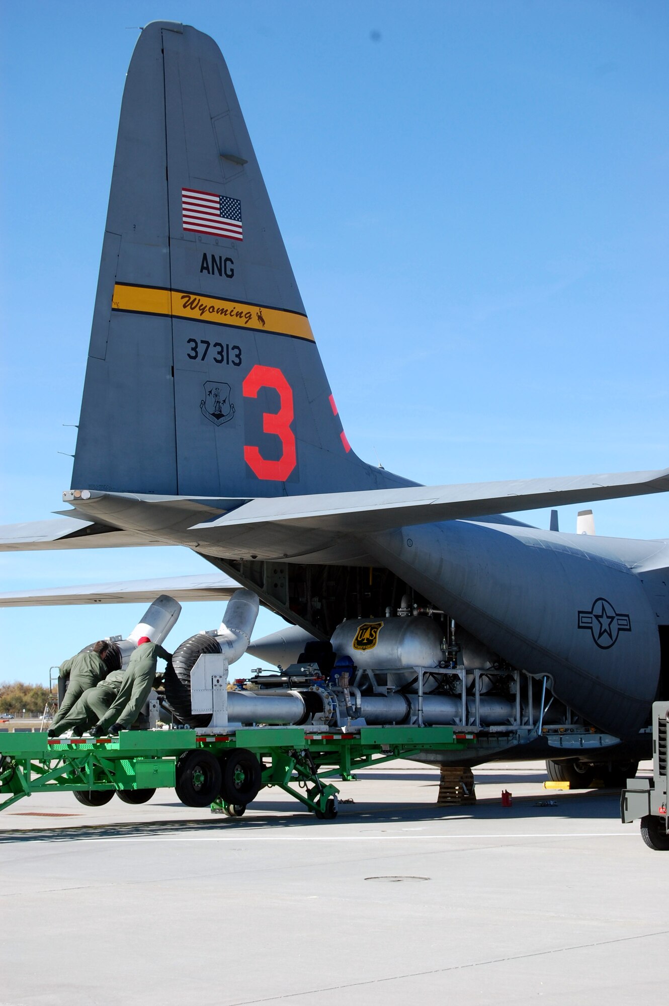 Airmen from the Wyoming Air National Guard load the Modular Airborne Fire Fighting System onto a Wyoming Air National Guard C-130 Hercules Oct. 23 in Cheyenne, Wyo. The C-130 is being deployed to California to assist with firefighting efforts. Fires have ravaged Southern California forcing more than 500,000 people from their homes as the president has declared a federal emergency for seven counties in the state. The orange number on the tail identifies the plane as one of the units using the Modular Airborne Fire Fighting System to battle the blaze. (U.S. Army photo) 
