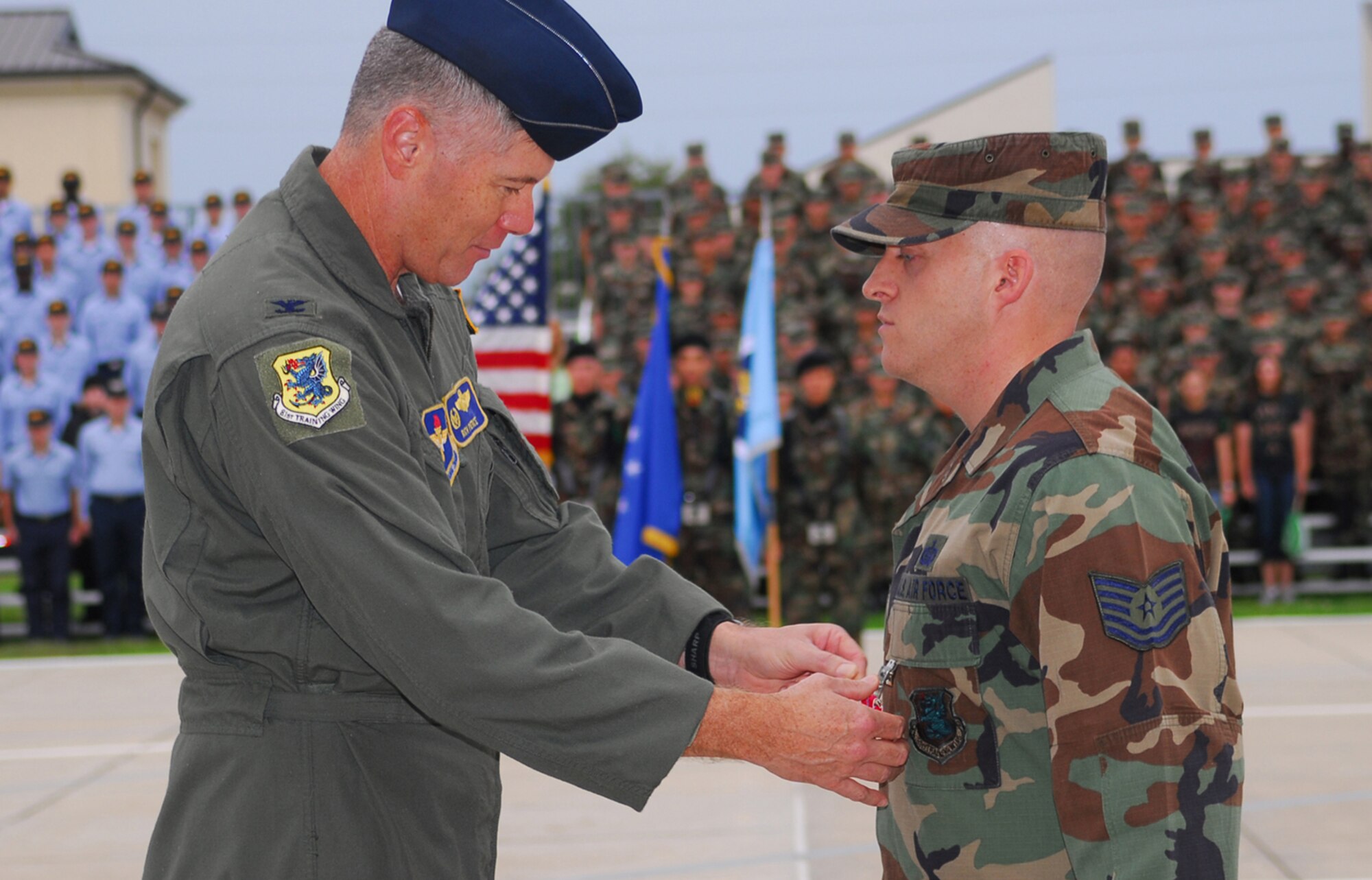 Col. Richard Pierce, 81st Training Wing vice commander, pins Bronze Star medal on Tech. Sgt. Michael Soucy, 81st TRW intelligence analyst, at the drill down Friday.  Sergeant Soucy received the nation’s fourth highest decoration for his service during a deployment to Balad Air Base, Iraq, May-November 2006.  (U.S. Air Force photo by Kemberly Groue)