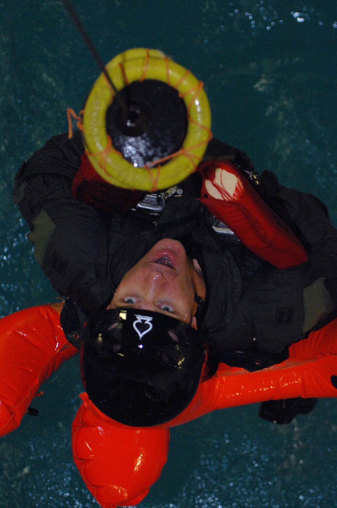Captain Scott Morison being pulled up by a water rescue device used for rescue by helicopter held at Lowestoft College, Maritime and Offshore Facilities. During the water survival training students are hit with 5-foot waves, pounding rain and brutal winds – all while soaking in valuable information crucial to keeping them alive. (U.S. Air Force photo by Senior Airman Teresa M. Hawkins)