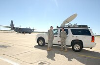 Department of the Army civilians Mike Geffendal, left, and Joshua Wood, U. S. Army North Command, wait at Lackland AFB, Texas, Oct. 23, 2007, to load their Emergency Response Vehicle for a flight to help with the California fires. (USAF photo by Alan Boedeker)                                                            