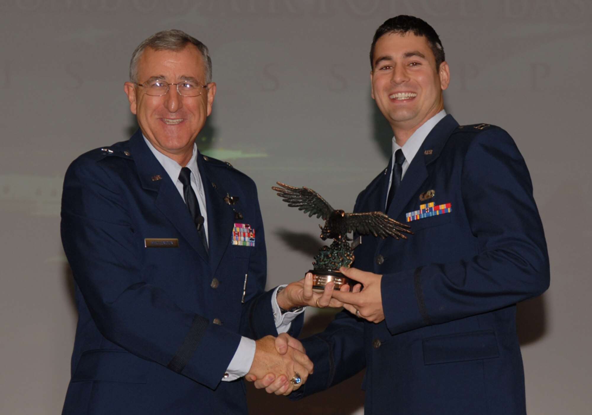 Brig. Gen. Mike McClendon, Commander, Air Force Global Cyberspace Integration Center, Langley AFB, Va., presents the  Air Education and Training Command Commander's Trophy to Capt. Jeffrey Harding. The general was the keynote speaker at the Specialized Undergraduate Pilot Training Class 08-01 graduation last Friday. (U.S. Air Force photo)