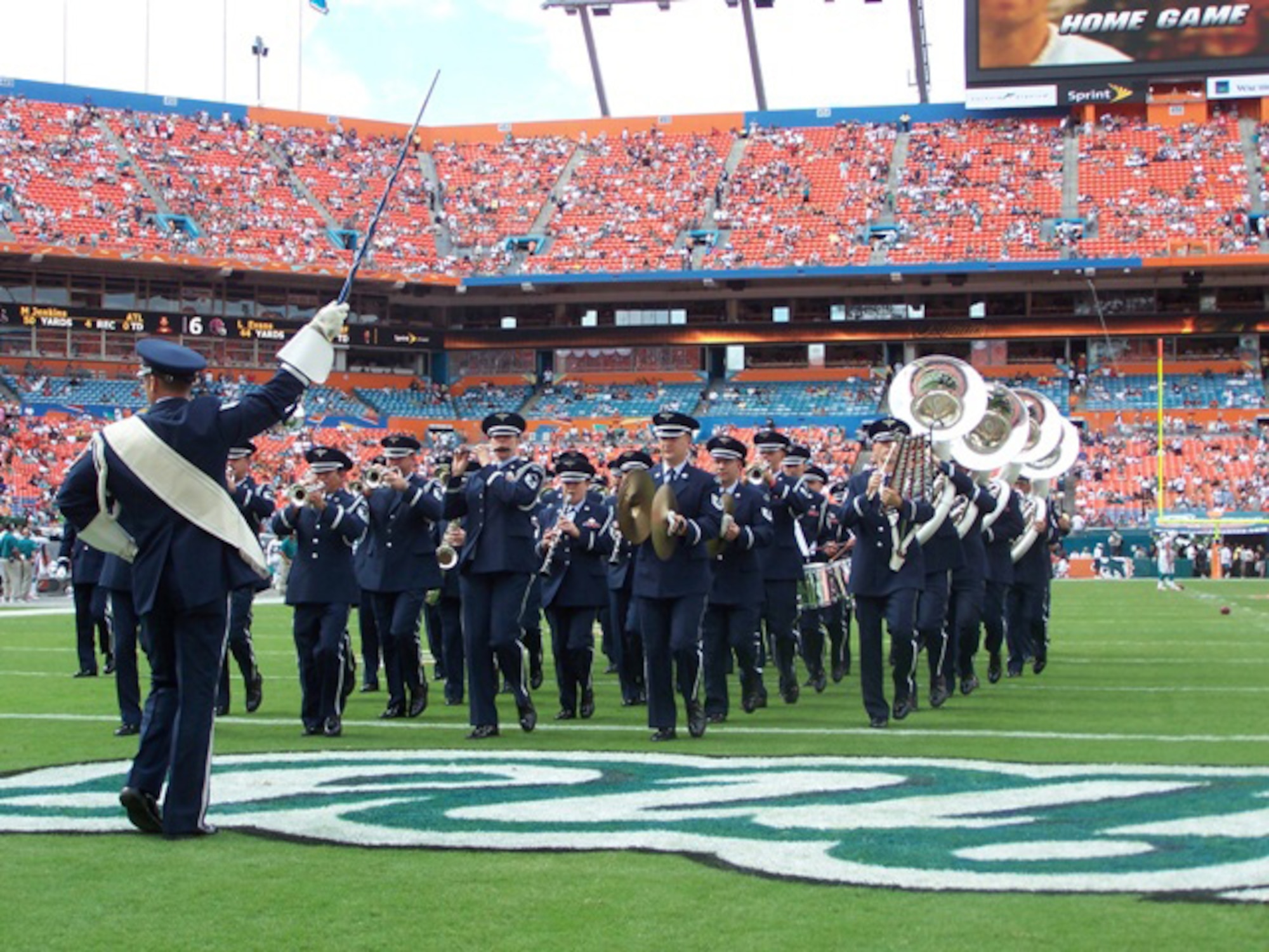 The Air Force Academy Band marches onto the field during the Miami Dolphins vs. New England Patriots halftime show on Oct. 21. The band requested support from Homestead Air Reserve Base for the halftime show, and the invitation was extended to servicemembers from U.S. Southern Command Headquarters, the Coast Guard and University of Miami Air Force ROTC. (U.S. Air Force photo/Lt. Col. Tom Davis)