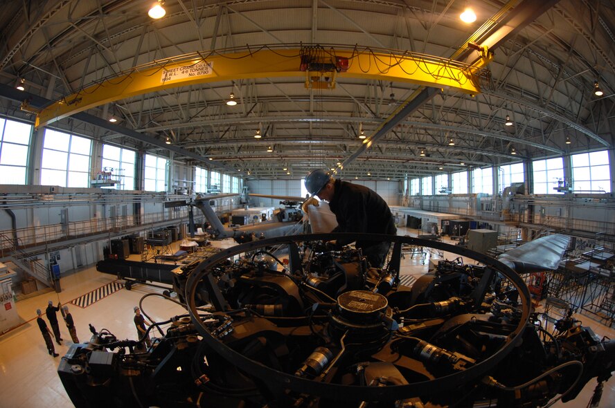 Positioned near the rotor head on top of one of five MH-53M Pave Low IV Helicopters assigned to the 21st Special Operations Squadron, Senior Airman Brad Renninger, a crew chief in the 352nd Maintenance Squadron, removes bolts that hold the rotor blades in place, Oct. 02, 2007, RAF Mildenhall, England. Once the tear down process is complete, it usually takes an average two days; the helicopters will be transported to the Aerospace Maintenance and Regeneration Group in Tucson, Ariz., commonly known as the 'Boneyard.' All Pave Low helicopters in the Air Force inventory are due to be grounded by October 2008. (U.S. Air Force photo by Tech. Sgt. Tracy L. DeMarco)