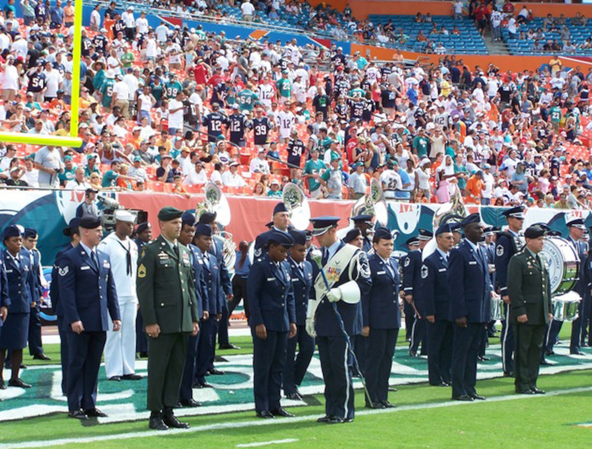 The Air Force Academy Band member aligns the formation of servicemembers from Homestead Air Reserve Base, U.S. Southern Command Headquarters, Coast Guard and University of Miami Air Force ROTC during the Miami Dolphins vs. New England Patriots halftime show on Oct. 21. (U.S. Air Force photo/Lt. Col. Tom Davis)