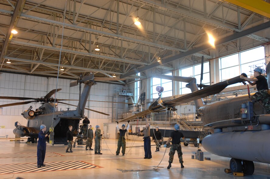 Crew chiefs and aircraft specialists in the 352nd Maintenance Squadron, Helicopter Maintenance Unit, remove rotor blades from one of the five MH-53M Pave Low IV Helicopters assigned to the 21st Special Operations Squadron, RAF Mildenhall, England, Oct. 02, 2007. Once the tear down process is complete, it usually takes an average two days; the helicopters will be transported to the Aerospace Maintenance and Regeneration Group in Tucson, Ariz., commonly known as the 'Boneyard.' All Pave Low helicopters in the Air Force inventory are due to be grounded by October 2008. (U.S. Air Force photo by Tech. Sgt. Tracy L. DeMarco)

