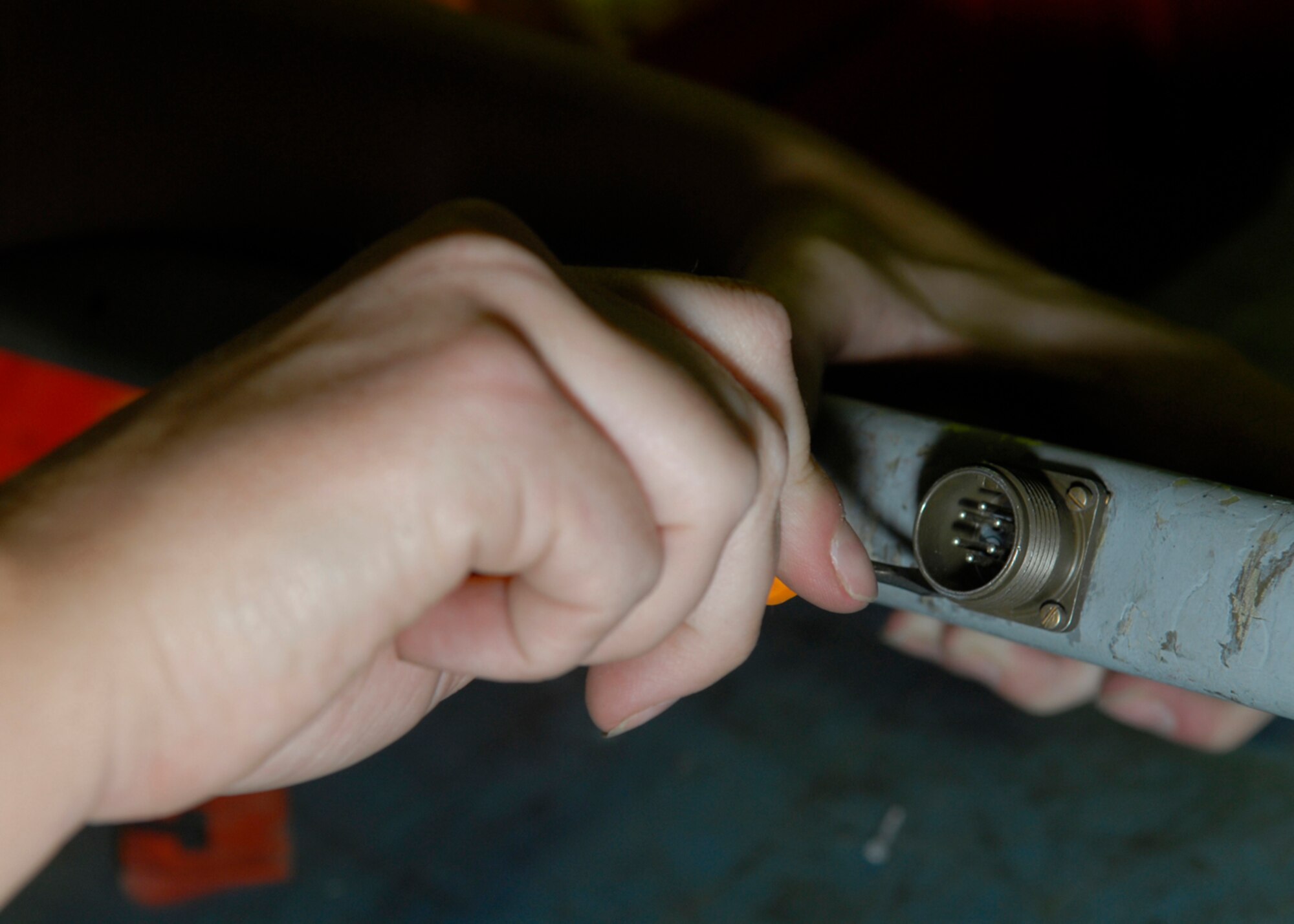 BALAD AIR BASE, Iraq -- Airman 1st Class Melissa Cunningham, 332nd Expeditionary Maintenance Squadron, tightens down the electrical connector on an ejector unit for the Triple Ejector Rack-9A. The TER-9A receives yearly inspections to ensure optimal performance. Airman Cunningham is currently deployed from Spangdahlem Air Base, Germany. (U.S. Air Force photo/Staff Sgt. Joshua Garcia)