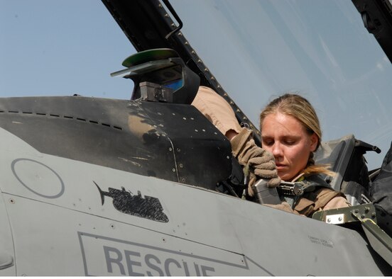BALAD AIR BASE, Iraq -- Capt. Caroline Jensen, 4th Expeditionary Fighter Squadron, connects the communications receiver to her helmet ensuring she is contact with personnel on the ground. All aircraft equipment is checked prior to a flight to ensure it is functioning properly. Captain Jensen is currently deployed from Hill Air Force Base, Utah. (U.S. Air Force photo/Staff Sgt. Joshua Garcia)