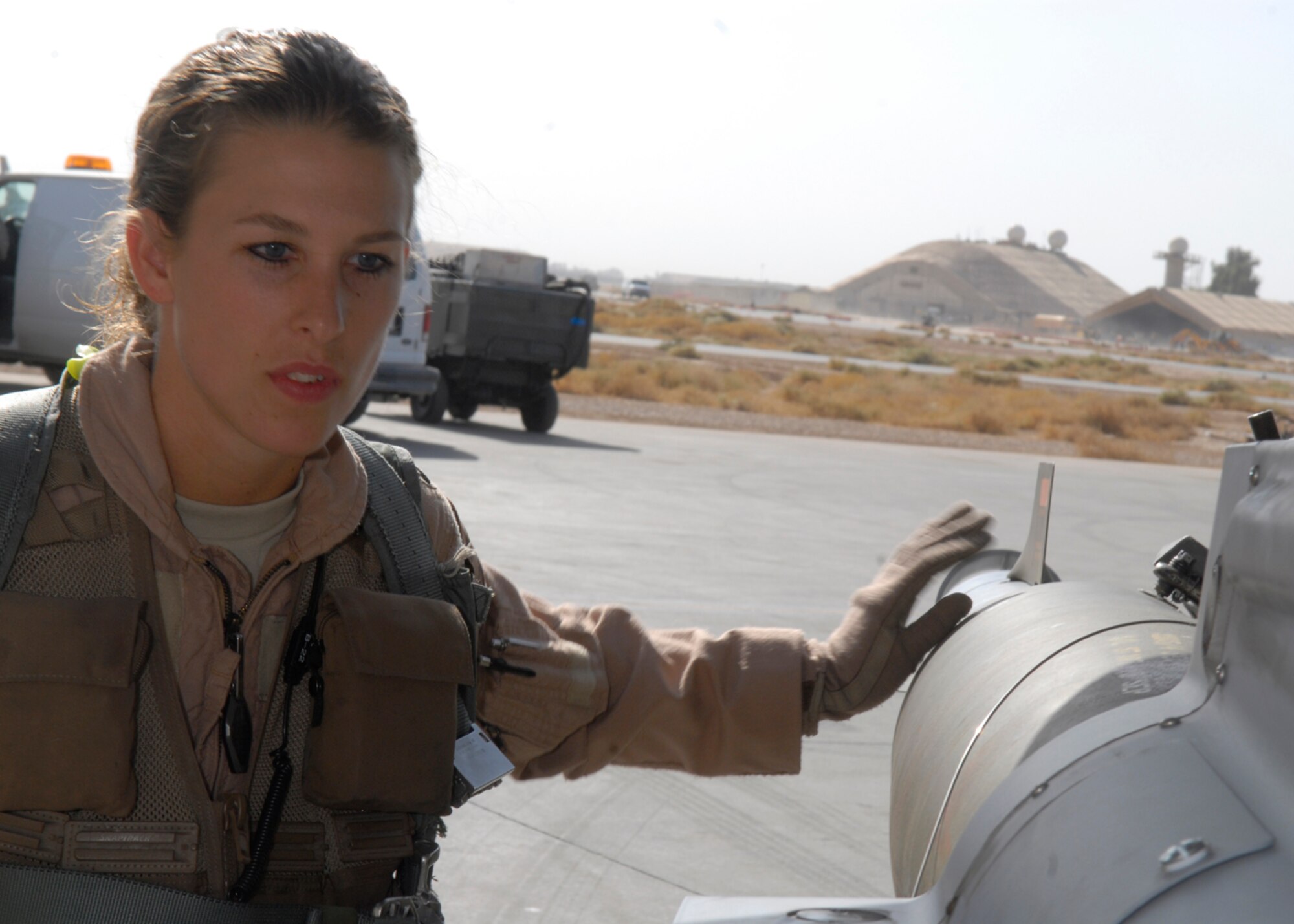 BALAD AIR BASE, Iraq -- Capt. Kerri Fulgham, 4th Expeditionary Fighter Squadron, inspects the exterior of her F-16 Fighting Falcon prior to takeoff here, Oct 23. Captain Fulgham is currently deployed from Hill Air Force Base, Utah. (U.S. Air Force photo/Staff Sgt. Joshua Garcia)