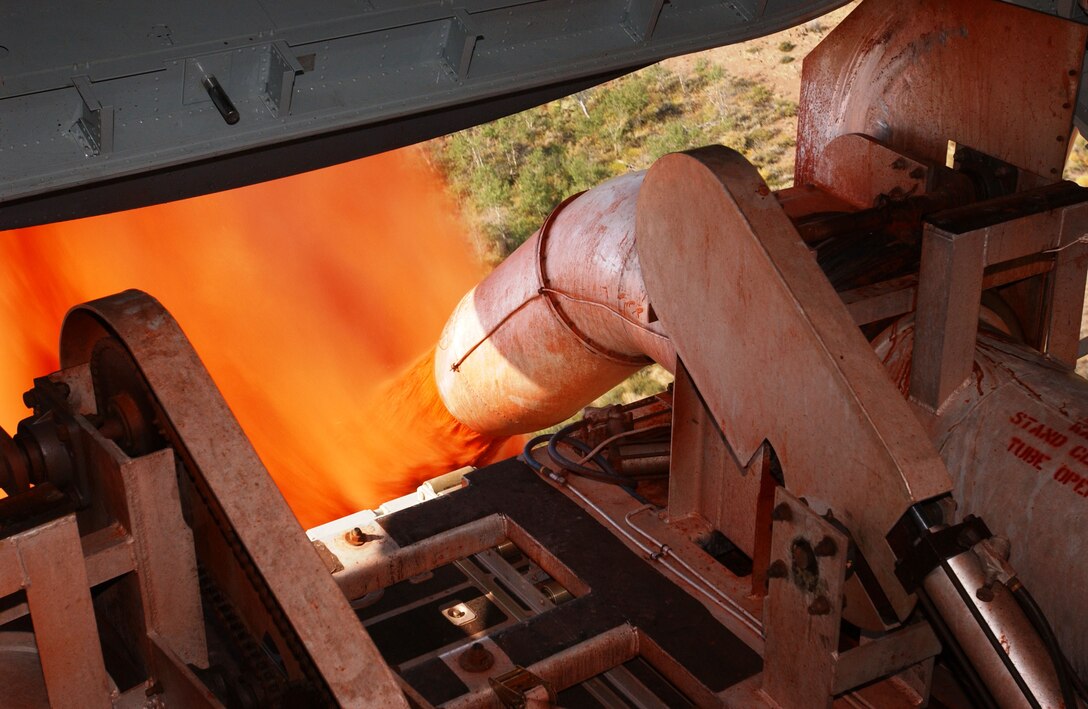 A Peterson Air Force Base, Colo, C-130 Hercules dispenses fire retardant liquid during a Modular Airborne Firefighting System mission in Klamath Falls, Ore. in the August 2006.  A MAFFS unit can discharge its load--3,000 gallons weighing 28,000 pounds--in a little over five seconds. (U.S. Air Force photo/Maj. James R. Wilson)