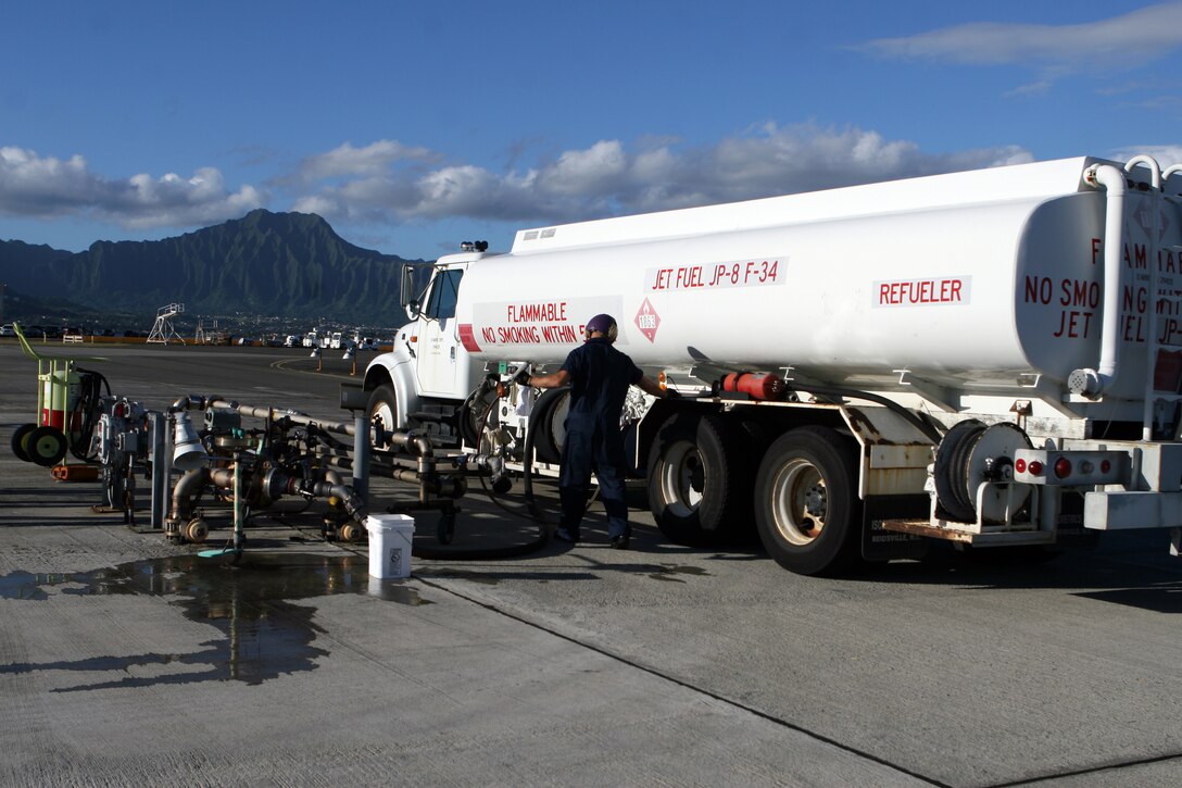 Corporal Robert Rakentine, fuels specialist, base fuels, Headquarters Battalion, fills a truck with jet fuel on the flight line, Wednesday. Base Fuels is responsible for providing fuel for various units, aircraft and vehicles around base.