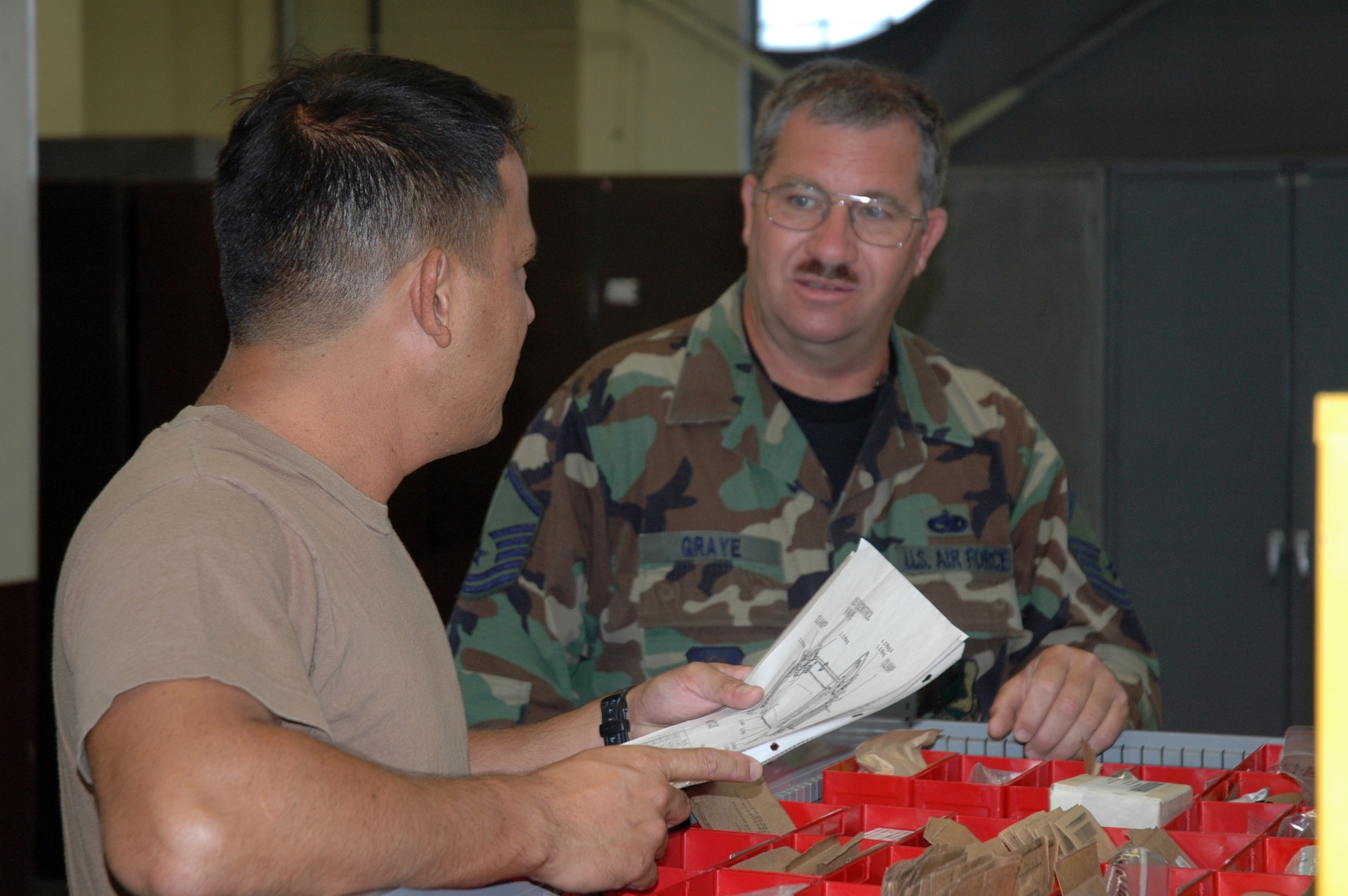 Master Sgt Gene Graye, 940th Maintenance Group electro-environmental technician, conducts end-of-the-year inventory with his counterpart at the 154th Maintenance Squadron, Hawaii Air National Guard. Sergeant Graye was one of a team of 35 that traveled to Hickam Air Force Base Sept. 14-28, 2007, to assist with mainenance on the Guard's KC-135s and the active duty's newest maintainer, the C-17. (US Air Force photo/Master Sgt Ellen L Hatfield) 
