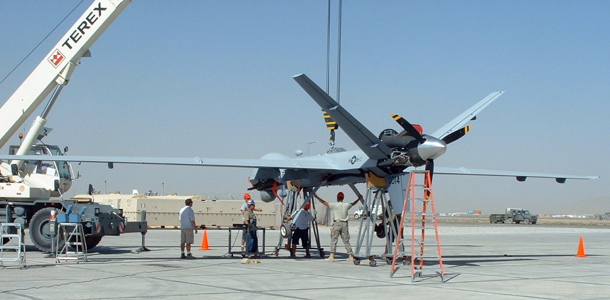 A team of testers lifts the MQ-9 Reaper Unmanned Aerial Vehicle for a landing gear operational check. The Air Force Operational Test and Evaluation Center Detachment 5 and the 31st Test and Evaluation Squadron recently tested the Reaper system's ability to deploy to a forward operating location in support of mission tasking. The team performed the testing at Kandahar Air Base, Afghanistan, from Sept. 4 through 25. (Courtesy photo)