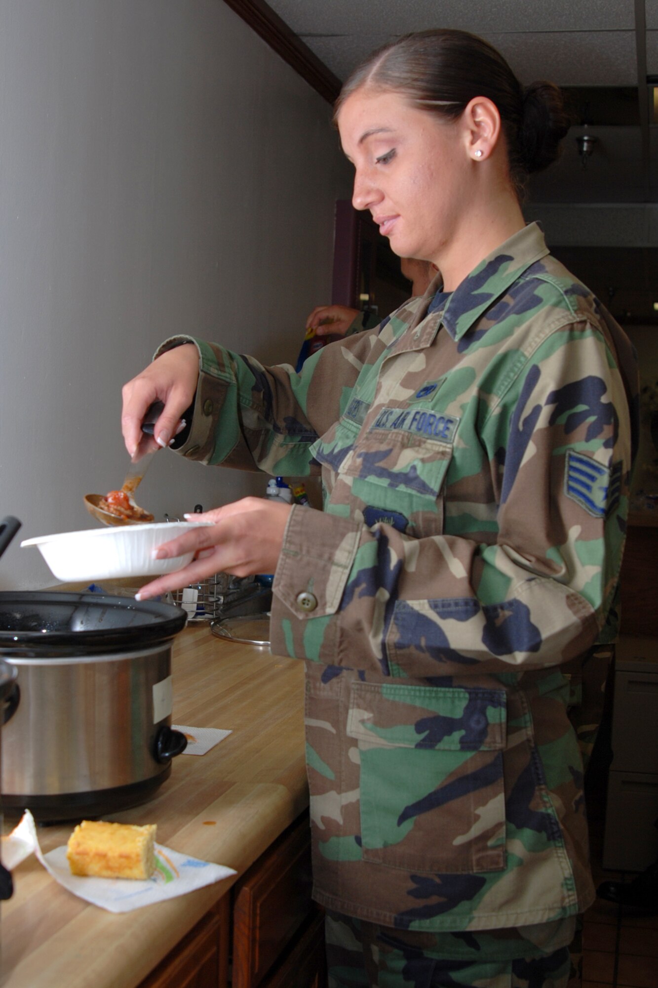 MCCONNELL AIR FORCE BASE, Kan. -- Staff Sgt. Joanna Rogers, 22nd Maintenance Operations Squadron, pours a warm bowl of chili at the Combined Federal Campaign Chili Cook-off on Oct. 24. The cook-off added $154 towards the CFC goal of $115,000, which increased $1000 from last year’s campaign total. (Photo by Airman Maria Ruiz)