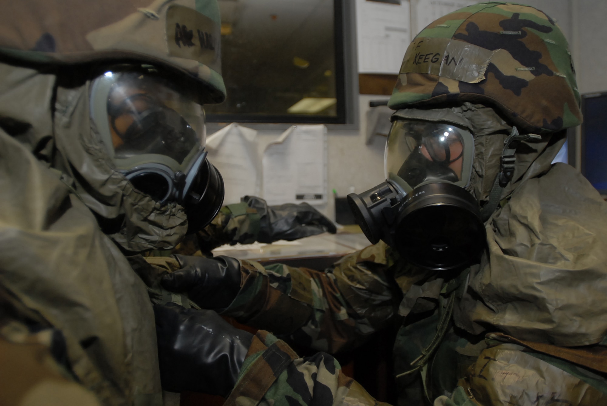 Airman 1st Class Marieto Tabajonda, 733rd Air Mobility Squadron, performs a buddy check on Airman 1st Class Steven Keegan, 733rd AMS. The Airmen put on their Mission Oriented Protection Posture gear during a simulated attack at Kadena Air Base, Japan, Oct. 25, 2007. The Airmen are supporting training missions based on real-world scenarios as part of Local Operational Readiness Exercise Beverly High 08-1. (U.S. Air Force photo/Senior Airman Darnell T. Cannady) 