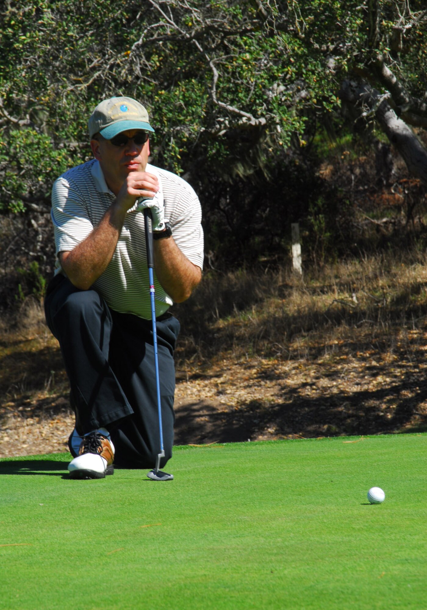 Lt Col. Steve Behrens, 30th Launch Control Group Vice commander, measures the distance before putting during the Big V golf tournament at the Village Country Club in Vandenberg Village on Oct. 19. The Tournament was hosted and paid for by the local community to support the military troops. (Photo by Airman 1st Class Ashley Tyler)
