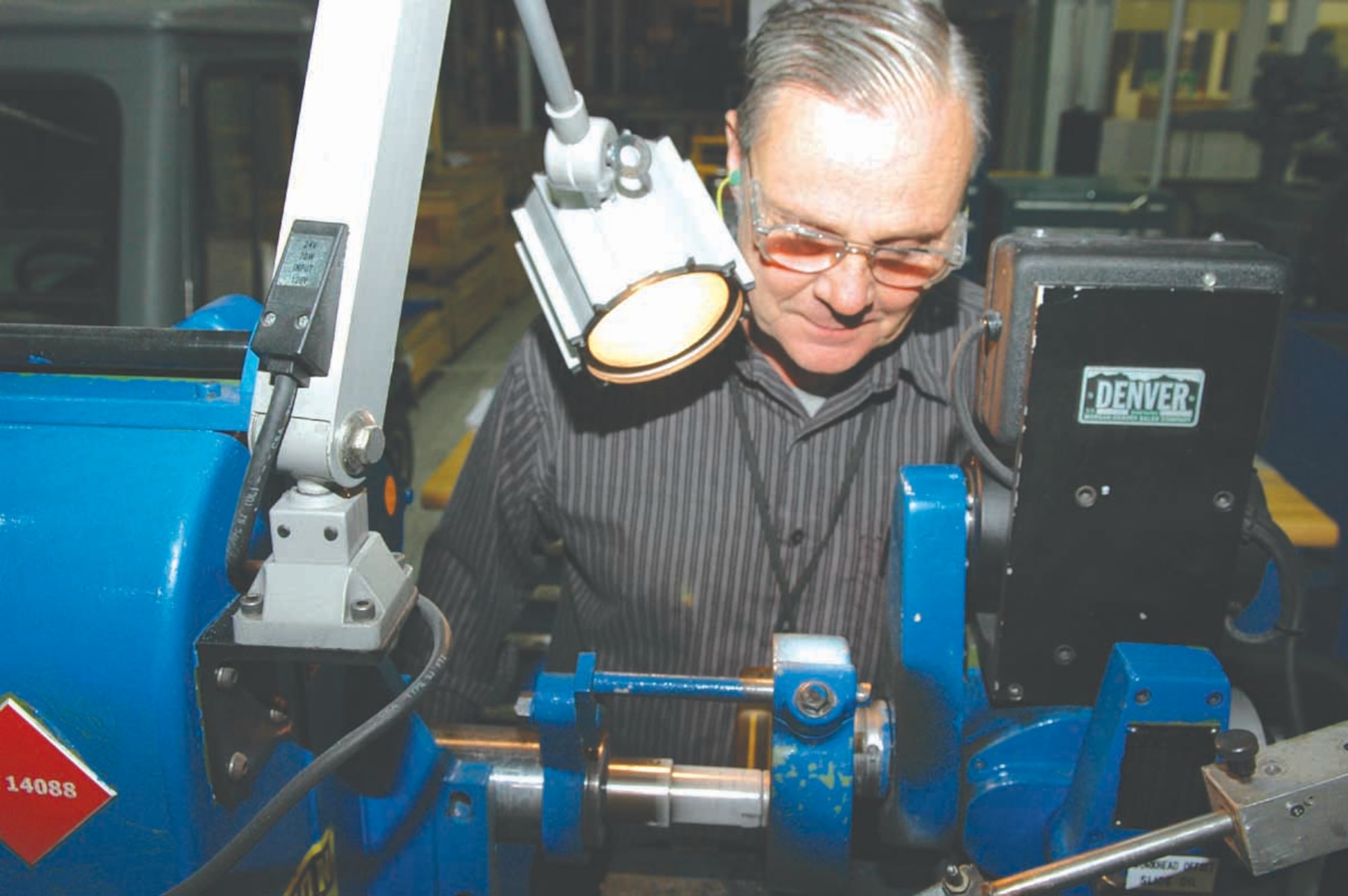 Ramsey Fletcher, a tool and die maker with the 547th Propulsion Maintenance Squadron, makes neoprene plugs for the TF33 engine on a cutter-grinder machine. (Air Force photo by Ron Mullan) 
