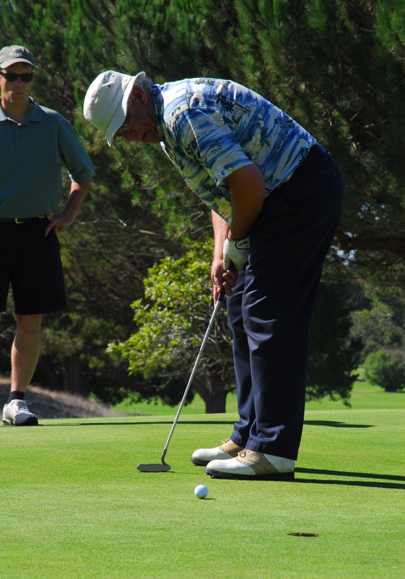 Dick Dewees, Mayor of Lompoc, California, is putting while Michael Forntey, 30th Space Wing Vice Commander, watches during the Big V golf tournament on Oct. 19. at the Village Country Club in Vandenberg Village, Calif. The event was hosted and paid for by the local community to support the military troops. (Photo by Airman 1st Class Ashley Tyler)
