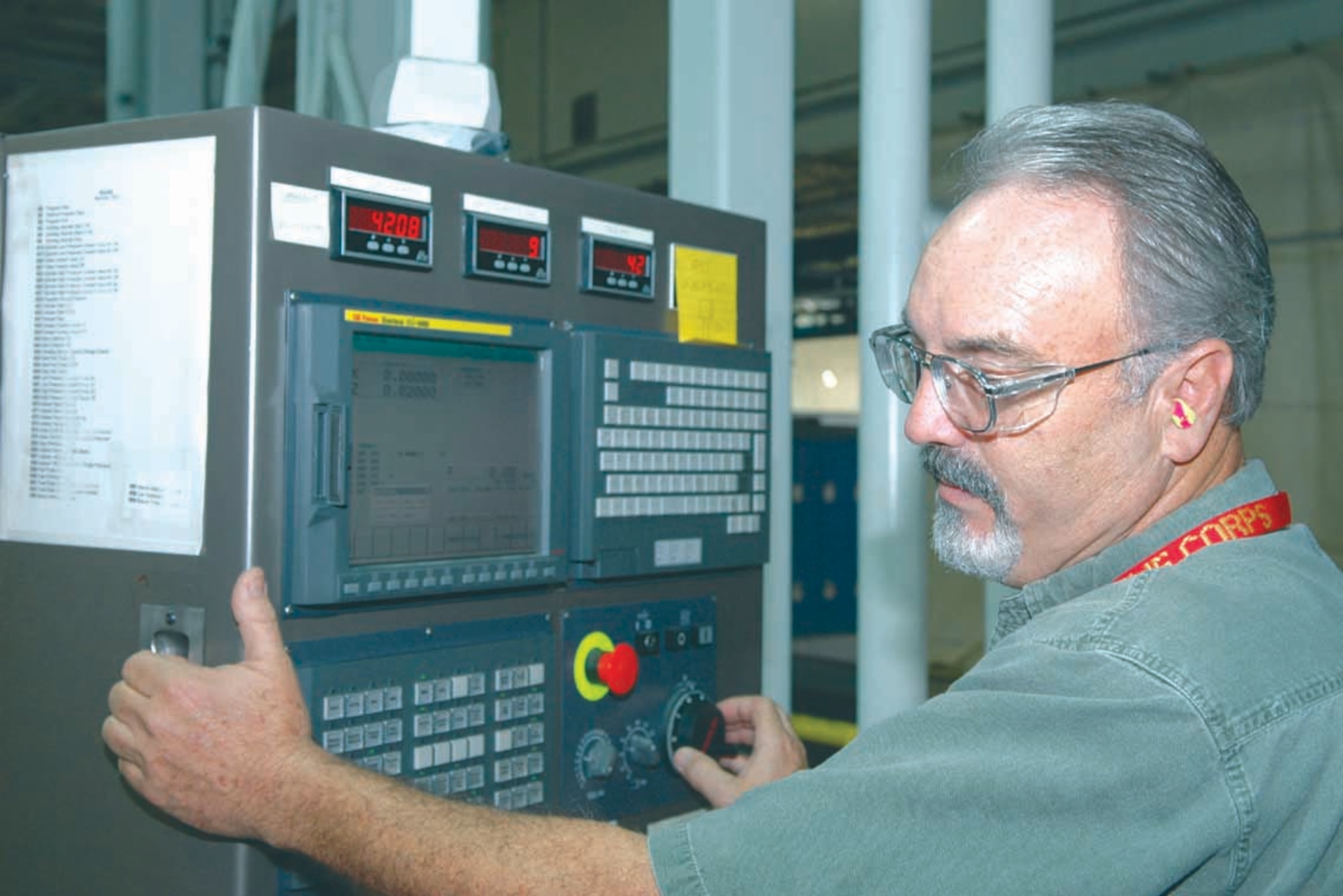 John Kelly, a toolmaker in the 547th Propulsion Maintenance Squadron, operates the controls of a Campbell Grinder machine, while monitoring the repair of a part from an F100 engine. (Air Force photo by Ron Mullan)