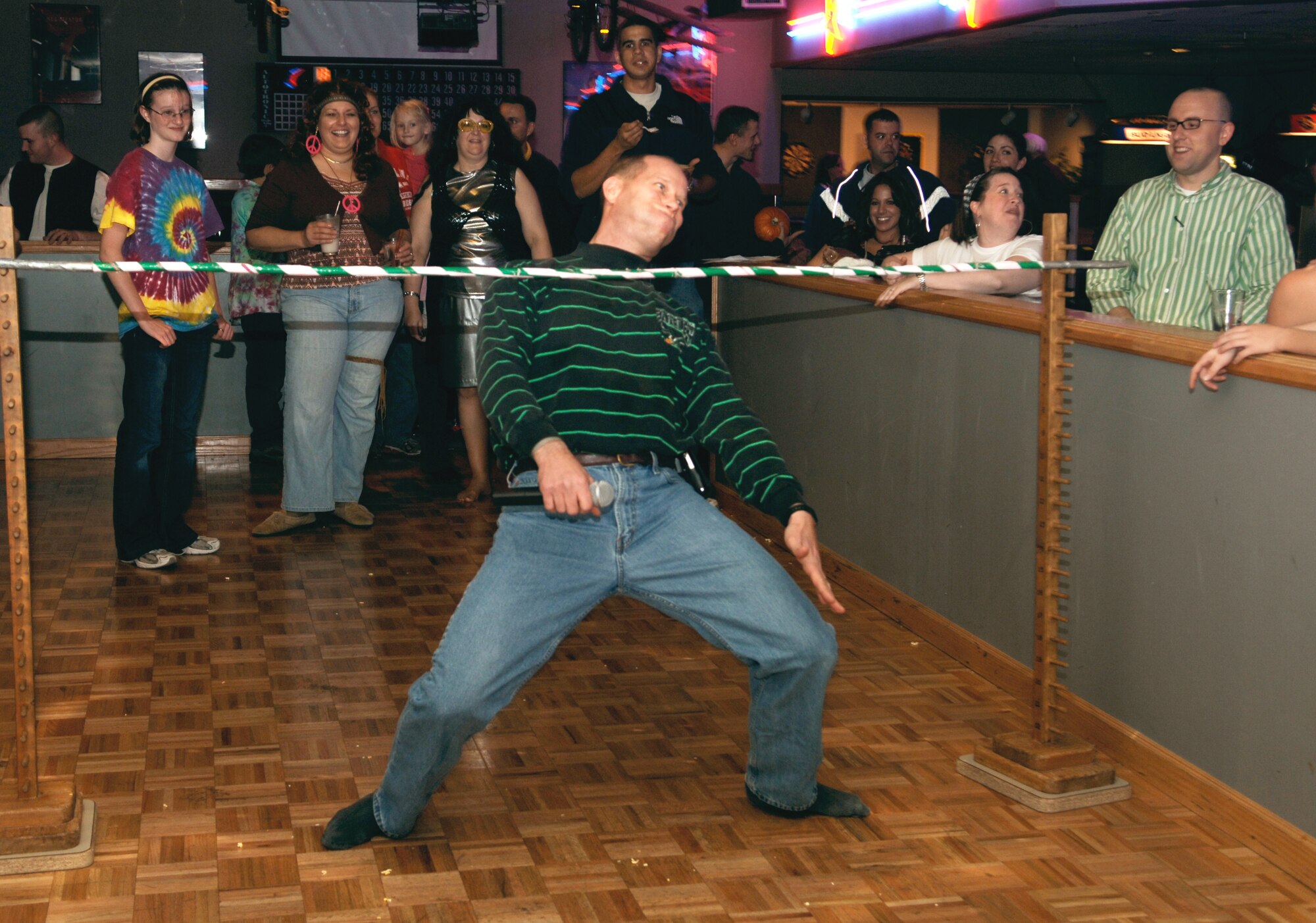 FAIRCHILD AIR FORCE BASE, Wash. -- Lt. Col. John Foden, 92nd Mission Support Group vice commander, attempts a limbo during the 92nd MSG Night at the Club held at Club Fairchild Oct. 19. Among other activities during the night, themed 70s night, was a tricycle race, pumpkin painting, trivia and a best dressed contest. (U.S. Air Force photo / Senior Airman Chad Watkins)