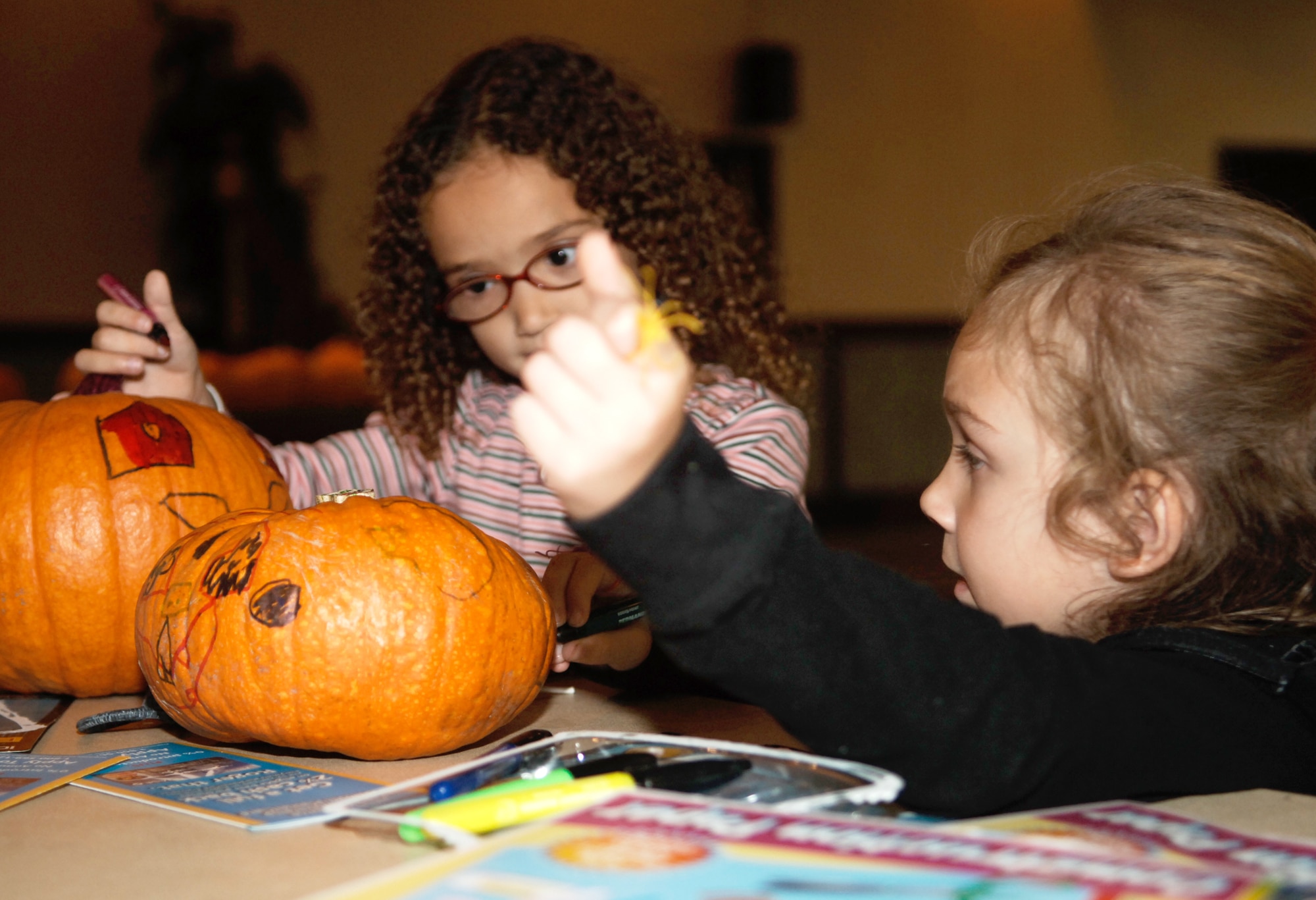 FAIRCHILD AIR FORCE BASE, Wash. -- Sam Knight and Julia Fromm paint pumpkins at the 92nd Mission Support Group Night at the Club held at Club Fairchild Oct. 19. The 92nd MSG sponsored a 70s night full of fun, food, games and prizes. (U.S. Air Force photo / Senior Airman Chad Watkins)