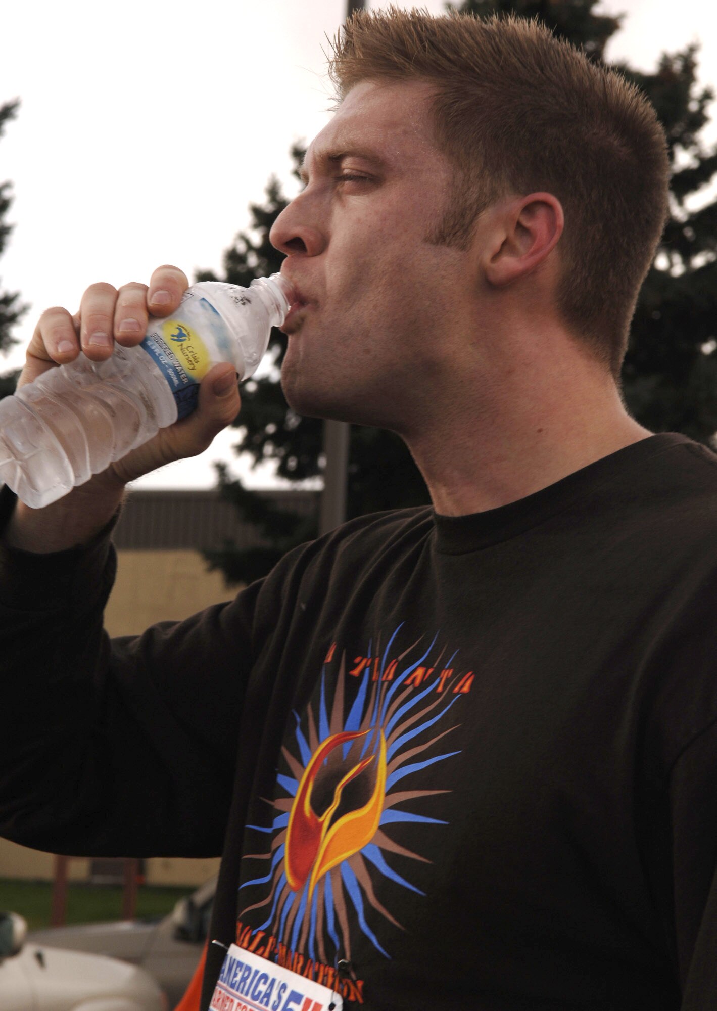 FAIRCHILD AIR FORCE BASE, Wash. – Staff Sgt. Jacobus Jens, 92nd Operations Support Squadron, re-hydrates after the 5K Flightline Fun Run here Oct. 19. Sergeant Jens took first place on the Male-Under 30 category, with a time of 29 minutes, 28 seconds. Other run winners were: Male-Over 30, Senior Airman Frank Cottongin, 92nd OSS; Female-Under 30, 1st Lt. Cat Christ, 93rd Air Refueling Squadron; and Female-Over 30, Tech. Sgt. Mickie Newman, 92nd Operations Group. In team awards, third place went to the 92nd Communications Squadron, second place to the 92nd Operations Support Squadron and first place to the 93rd Air Refueling Squadron. (U.S. Air Force photo/Airman 1st Class Darlene West)