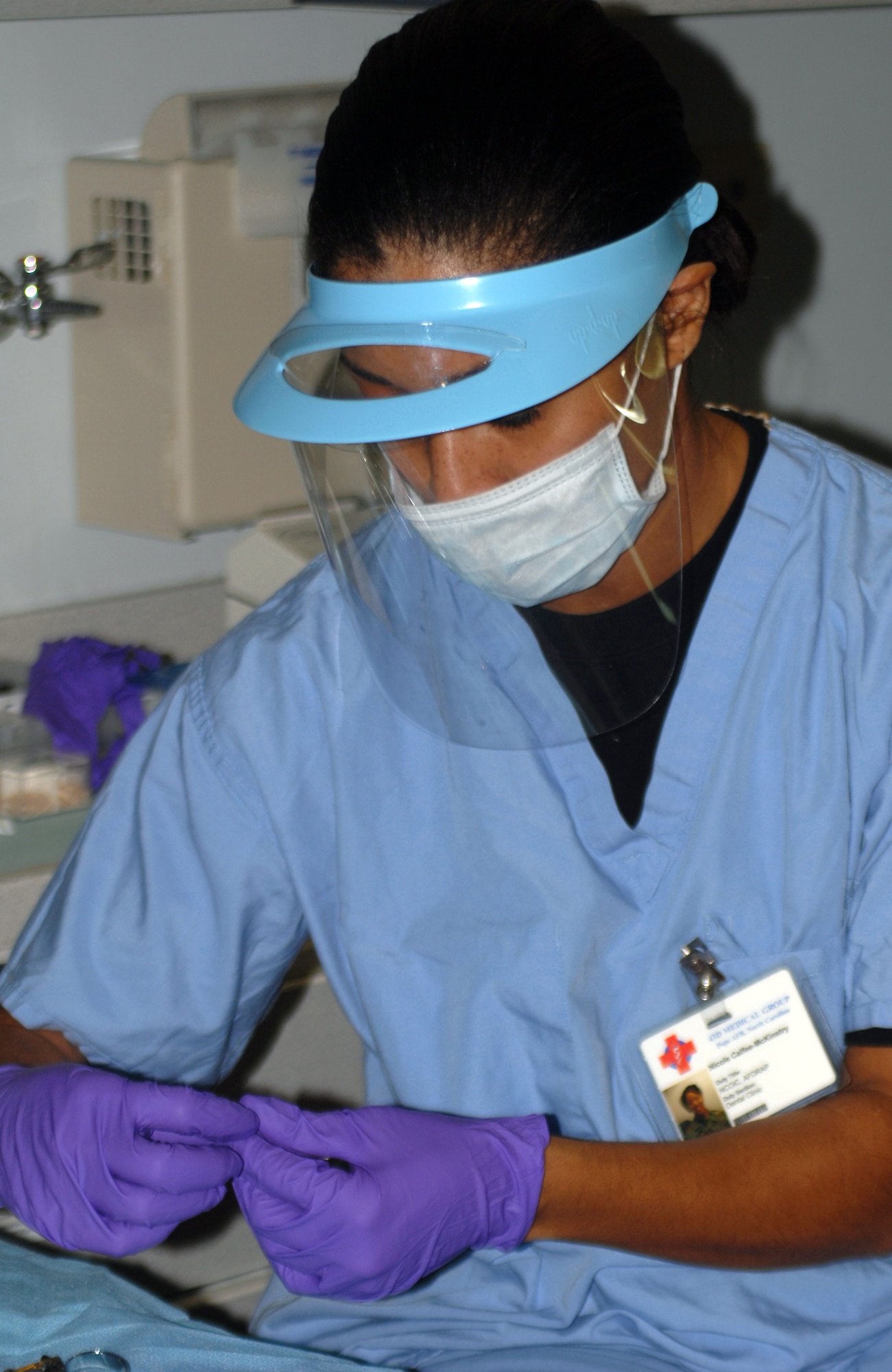 Staff Sgt. Nicole McKinstry prepares instruments for a patient's checkup Oct. 23 at the 43rd Aeromedical Dental Squadron at Pope Air Force Base, N.C. Sergeant McKinstry was diagnosed with breast cancer at age 28. She will be cancer-free four years in December. (U.S. Air Force photo/Airman Mindy Bloem)