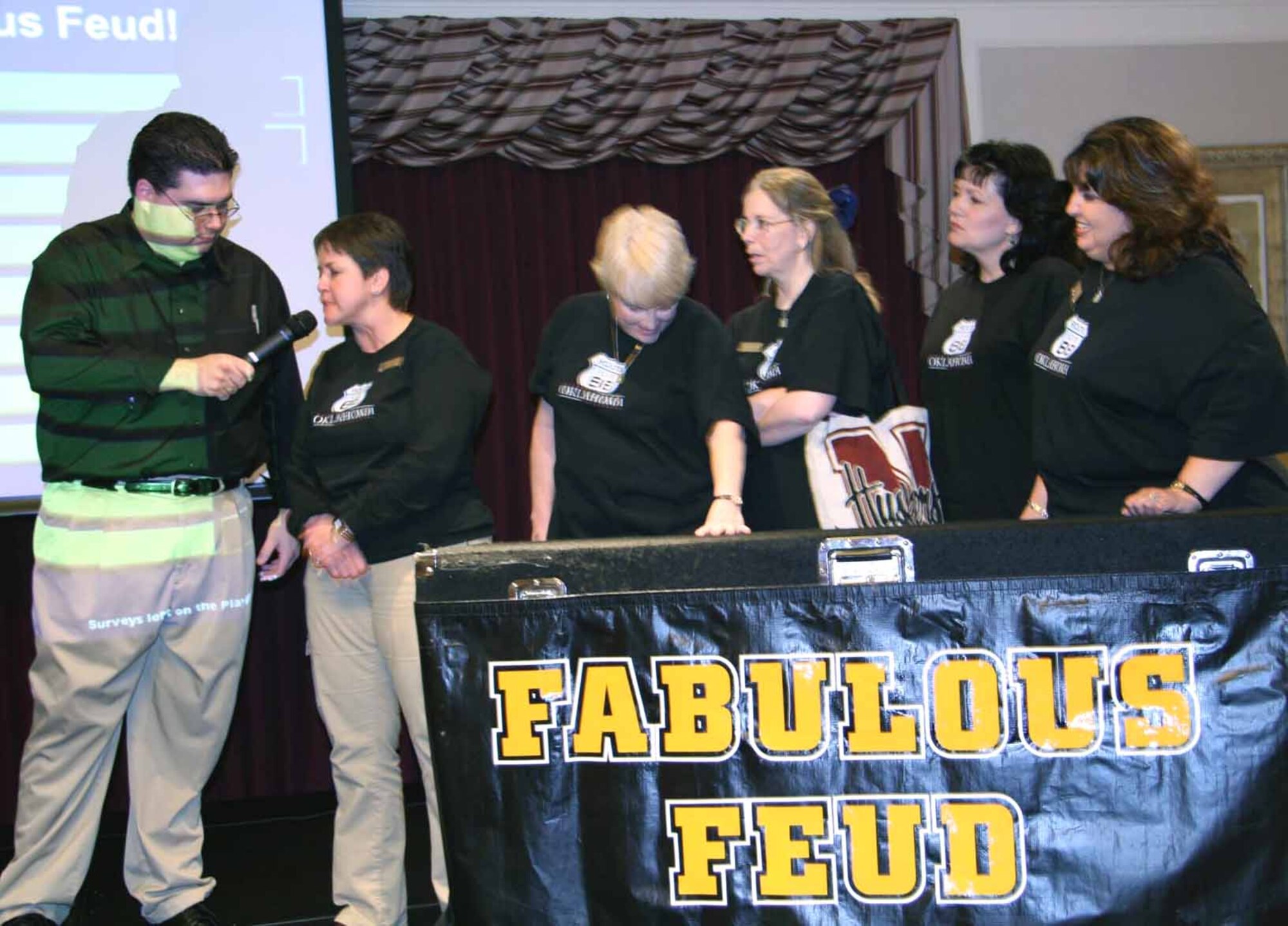 Game host Paul Spoerl talks with winners Theresa Farris, Col. Judy Kautz, Sharon Hebert, Mary Ann Briscoe and Naila Gutierrez during last year’s Fabulous Family Feud. This year’s event takes place from 4:30 to 8:30 p.m. Thursday at the Tinker Club. (Air Force photo by Becky Pillifant)
