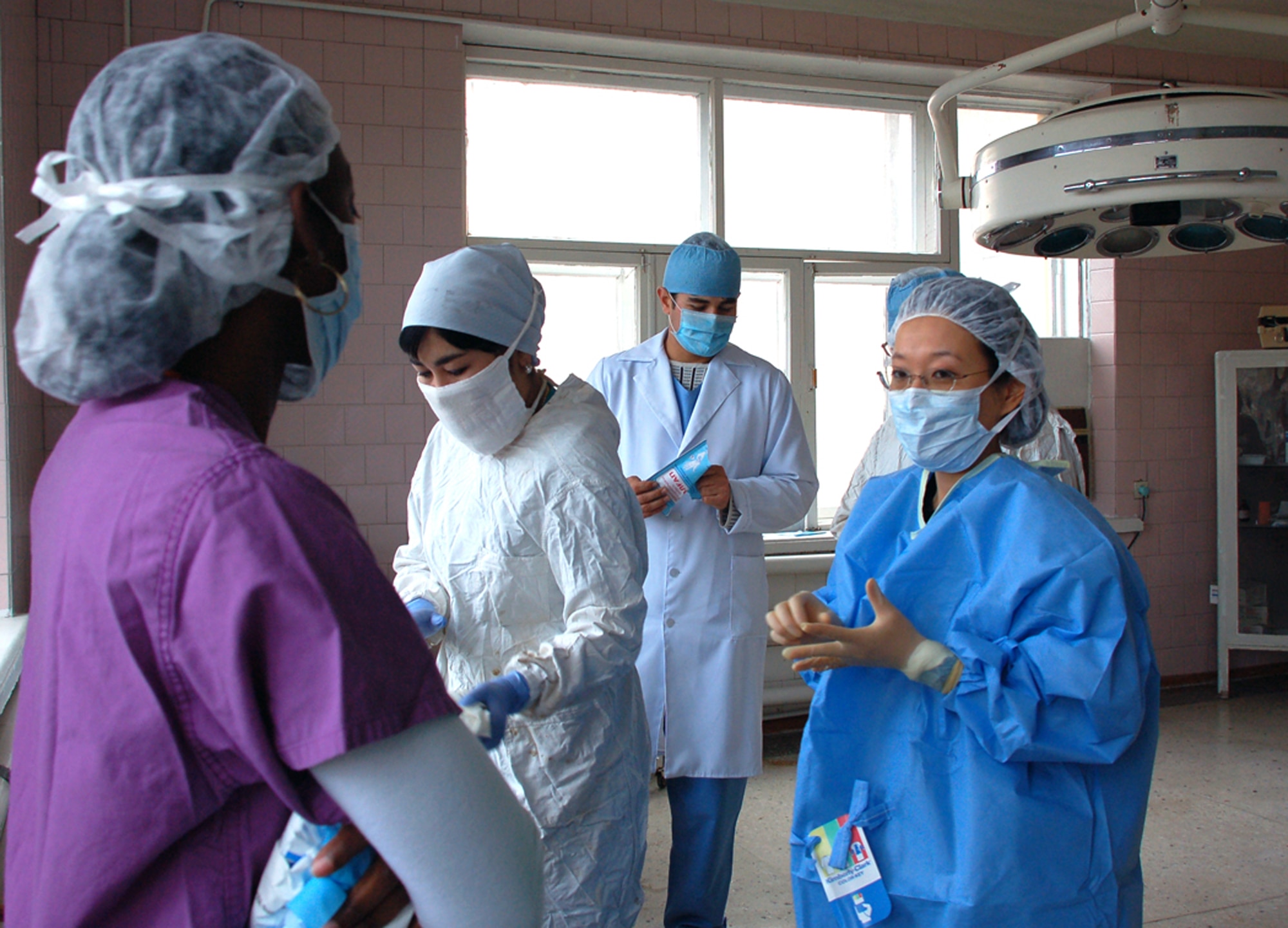 Tech. Sgt. Katrina Bowers watches as Maj. (Dr.) Christy Chai prepares to assist in a surgical case at the Kyrgyz Republic national surgical center  Oct. 24. Major Chai and Sergeant Bowers are assigned to the 376th Expeditionary Medical Group. (U.S. Air Force photo/Senior Airman Giana Jaworski)