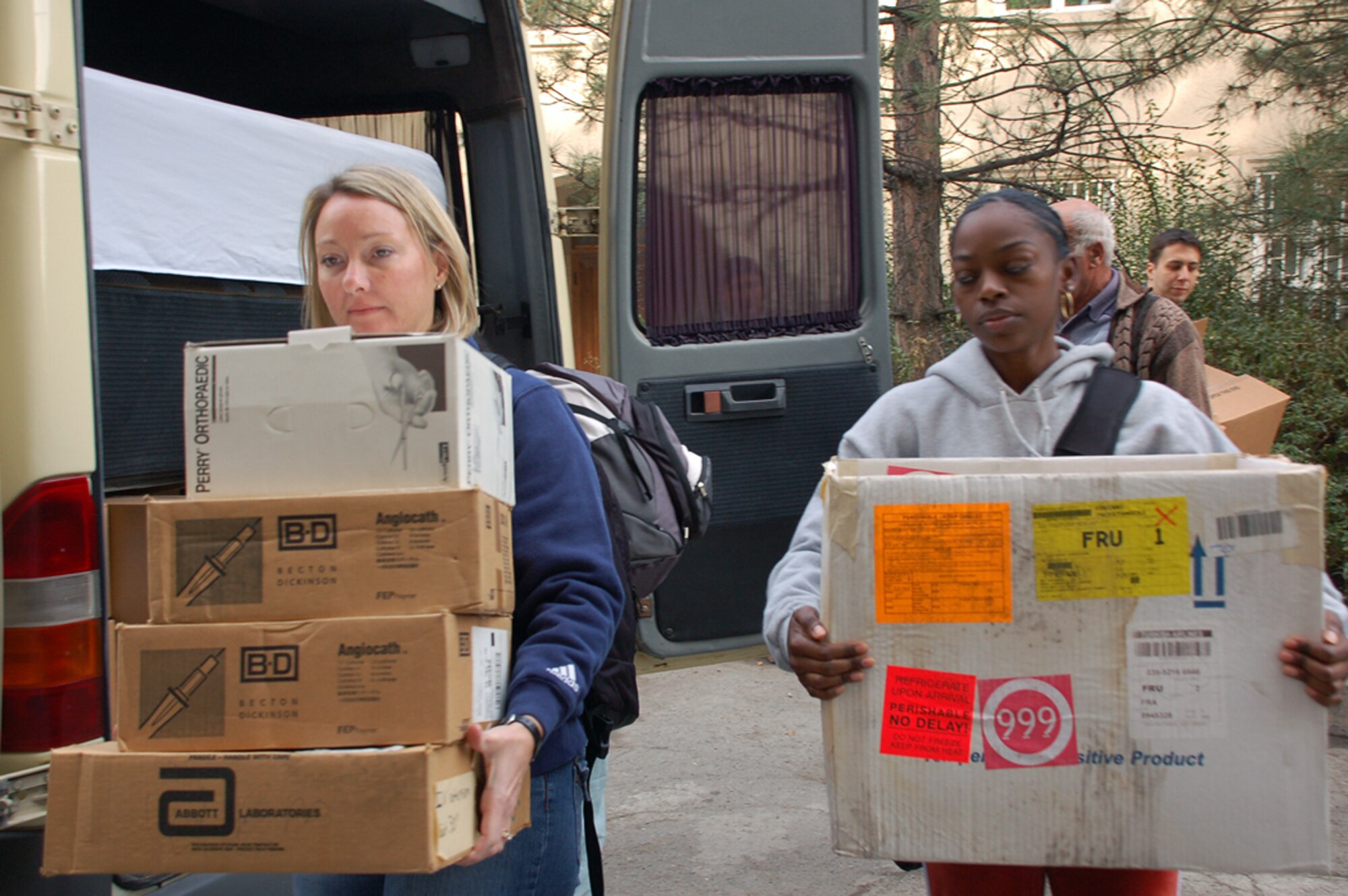 Capt. Cheryl Barnes and Tech. Sgt. Katrina Bowers unload donated supplies for the Kyrgyz Republic national surgical center Oct. 24. Captain Barnes and Sergeant Bowers are assigned to the 376th Expeditionary Medical Group. (U.S. Air Force photo/Senior Airman Giana Jaworski)
