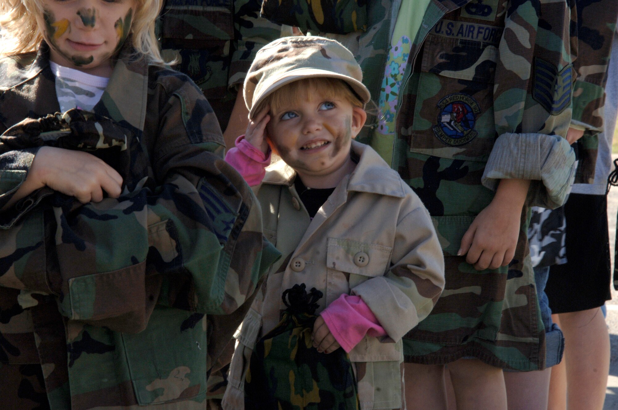 MCCONNELL AIR FORCE BASE, Kan. -- Caitlin Rash, 3, daughter of Staff Sgt. Christopher Rash, 22nd Aircraft Maintenance Squadron, practices her salute during the Kids Deployment Line Oct. 20.The Airman and Family Readiness Center coordinated a mock deployment event for the children of Team McConnell members to show them what parents do when they prepare to deploy. (Photo by Airman 1st Class Justin Shelton)