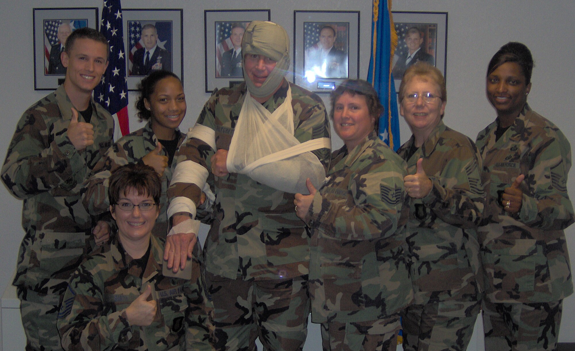 Members from the 22nd Mission Support Squadron attend squadron Self Air Buddy Care training Oct. 19. Back Row: Senior Airman Timothy Vojak, Airman 1st Class Frances Roberts, Chief Master Sgt. John Pritchett, Tech. Sgt. Brenda Hansen; Chief Master Sgt. Susan Ferguson and  Master Sgt. Cheryl Moye.  Front: Master Sgt. Susan Smith. 
“Learning doesn’t have to be dry and boring,” said Chief Master Sgt. Susan Ferguson, 22nd MSS.
“This class was the best I’ve attended in 27 years.  I learned about the new life saving tools that are available, trained on how to use them while at the same time getting to assist the group dress and bandage the biggest character on base, Chief Master Sgt. John Pritchett,” she said.  “When you learn and laugh, you remember twice as much for twice as long.”  (Photo by Gwen Turner)  
