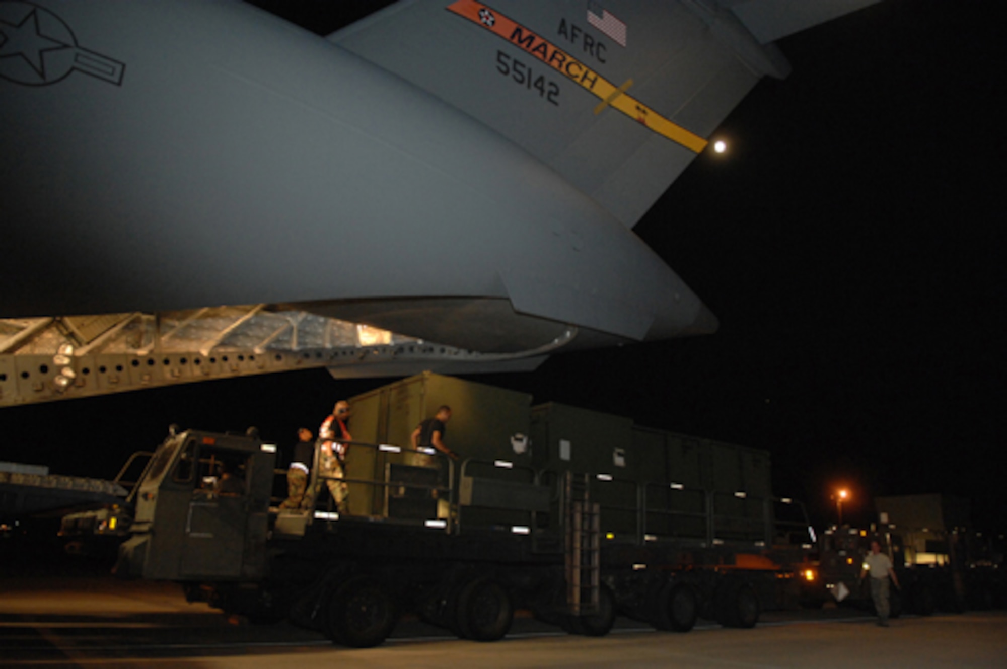 Air Force reservists from the 452nd Air Mobility Wing help the U.S. Army North from Fort Sam in Houston, Texas, unload emergency response equipment from an Air Force Reserve Command C-17 Globemaster III aircraft at March Air Reserve Base, Calif., Oct. 24, 2007. March ARB is being used as a staging in the fight against wildfires in Southern California. (U.S. Air Force photo/Staff Sgt. Hector Garcia) 