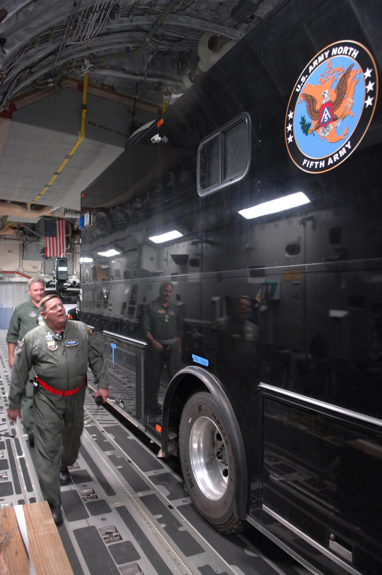 An Air Force load master inspects arriving cargo as Air Force reservists from the 729th Airlift Squadron deliver two U.S. Northern Command mobile command center vehicles to March Air Force Base, Calif., Oct. 24, 2007. The vehicles will provide command and control of relief operations in response to the devastating California wildfires. (U.S. Air Force photo/Master Sgt. Steve Cline)