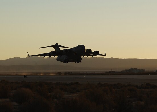 A C-17 Globemaster III takes off from Edwards Air Force Base, Calif., on Oct. 19. The early-morning flight marked the first flight of the C-17 using a Fischer-Tropsch synthetic fuel blend in one of its engines. All four engines ran the fuel blend during an Oct. 22 test flight. (Air Force photo by Jim Shryne) 