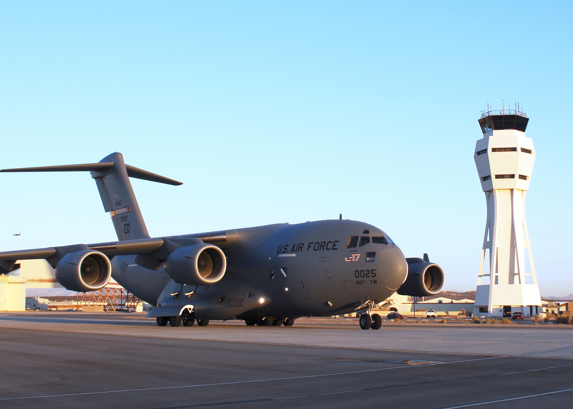 A C-17 Globemaster III taxis past the control tower at Edwards Air Force Base, Calif., on Oct. 19. The early-morning flight marked the first flight of the C-17 using a Fischer-Tropsch synthetic fuel blend in one of its engines. All four engines ran the fuel blend in subsequent tests. (Photo by Jim Shryne)