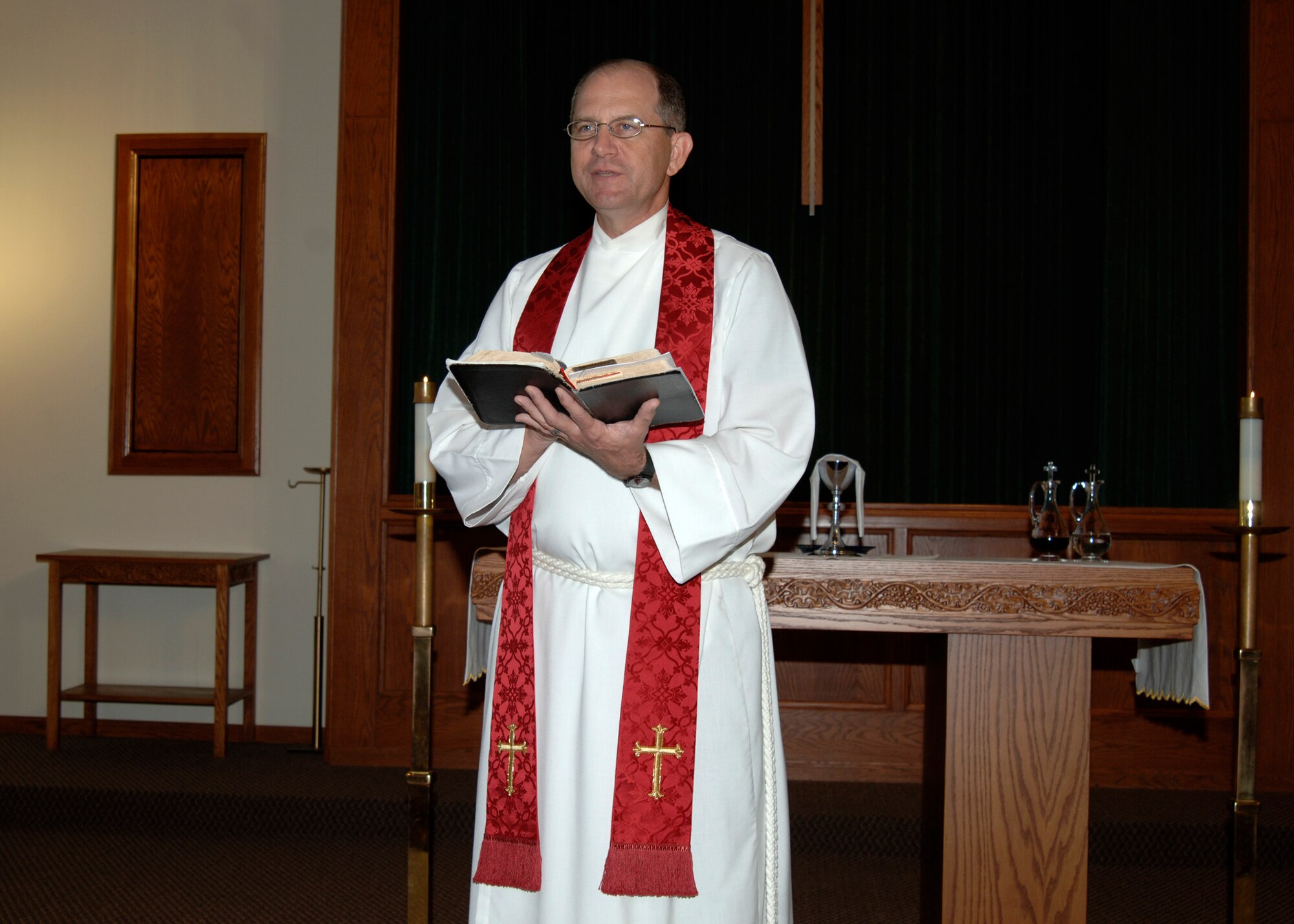 MCCONNELL AIR FORCE BASE, Kan. -- Chaplain (Lt. Col.) Michael Williams, 22nd Air Refueling Wing Chapel Service Team, reads a scripture from the bible during the Episcopal Service Oct. 23. The Episcopal Service is just one of many services held at the base chapel; all services are open to the public and different time frames to help cater to the people.  (Photo by Airman First Class Justin Shelton) 