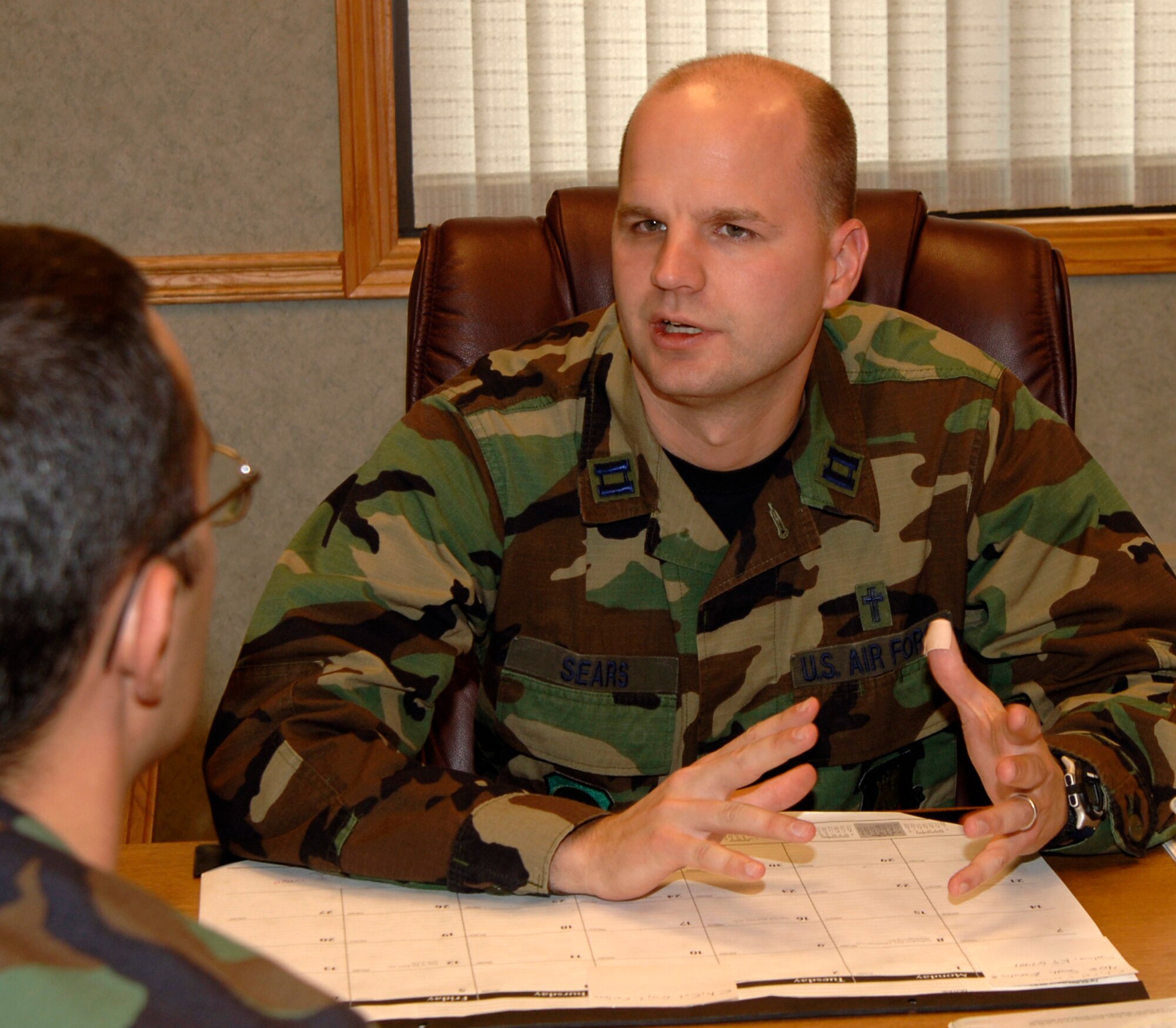 MCCONNELL AIR FORCE BASE, Kan. – Chaplain (Capt.) Travis Sears, Protestant Chaplain, sits down and takes time to explain the breakdown of the Protestant denominations.  (Photo by Airman First Class Laura Suttles)