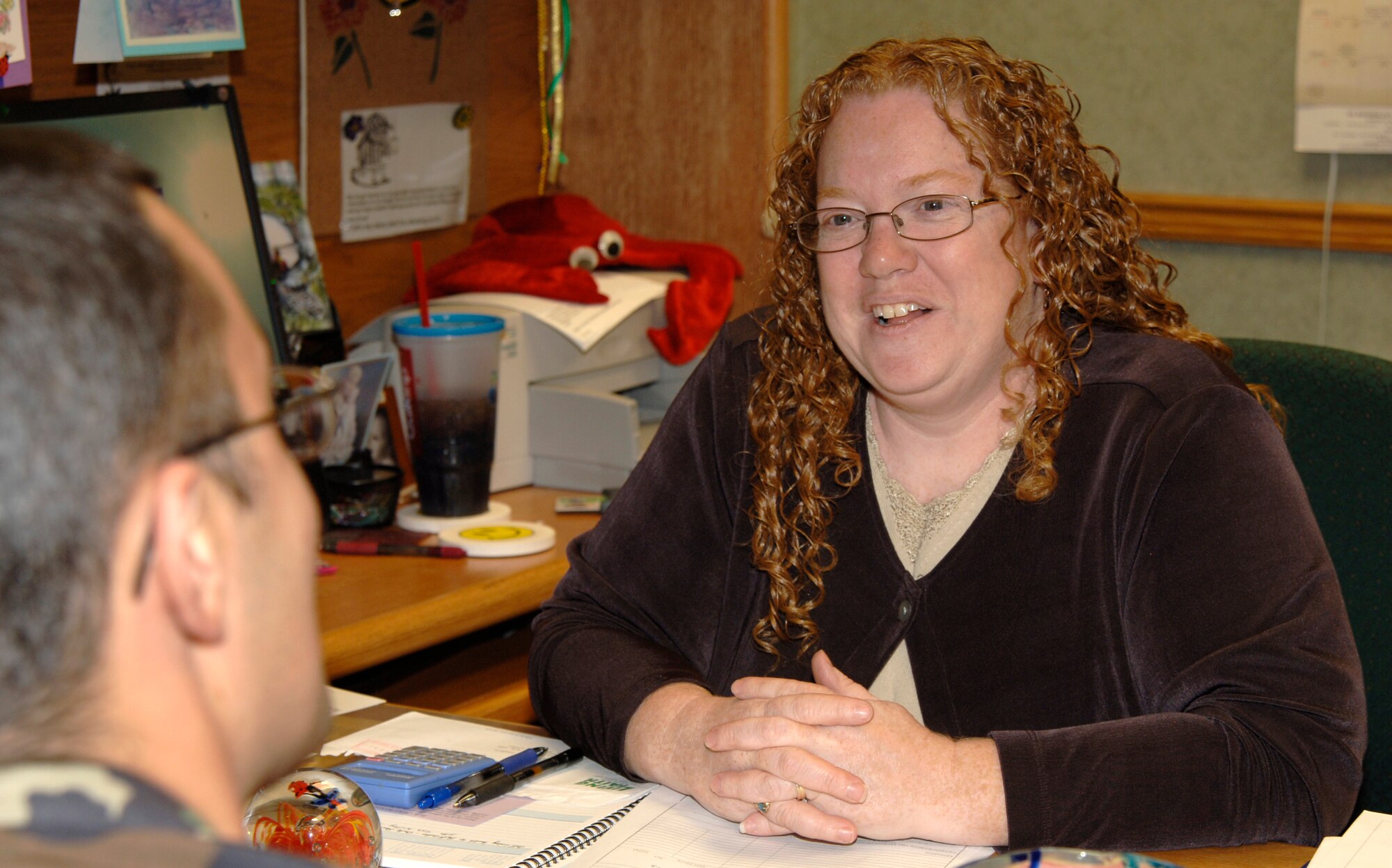 MCCONNELL AIR FORCE BASE, Kan. – Cathy Larkins, Catholic community and religious education coordinator, takes time to explain how she coordinates all services at the chapel Oct. 22.  (Photo by Airman First Class Laura Suttles)