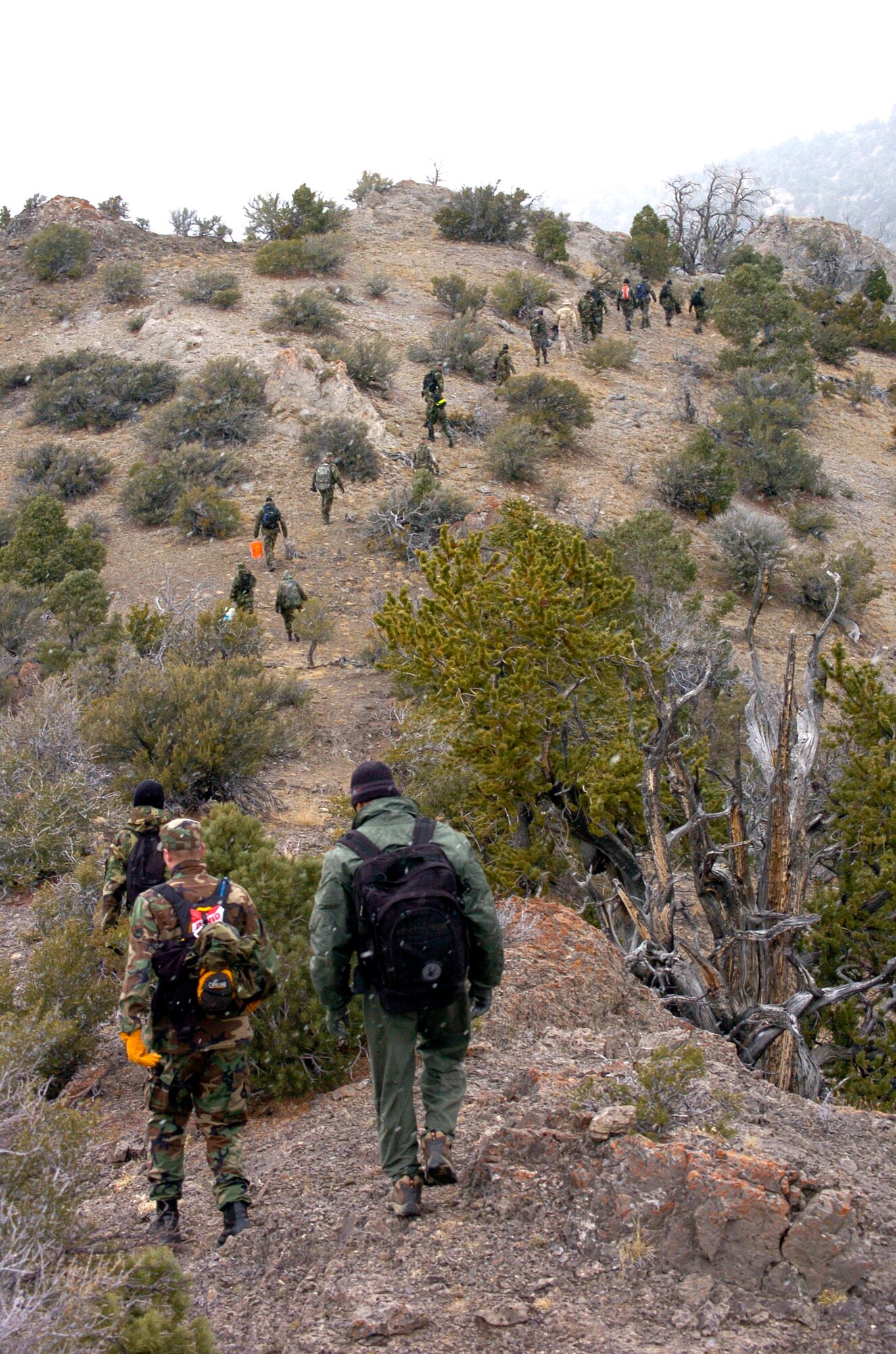 Volunteers from Hill Air Force Base, Utah, hike Oct. 17 to the site where an F-4 Phantom crashed nearly 30 years ago to help in the recovery of the aircraft remains. The aircraft crashed in the Deep Creek Mountains that span the Utah-Nevada border. The trip from the base camp to the crash site was eight miles through rock, dirt and dried creeks and took about 90 minutes to cover. (U.S. Air Force photo/Airman 1st Class Clayton Murray)

