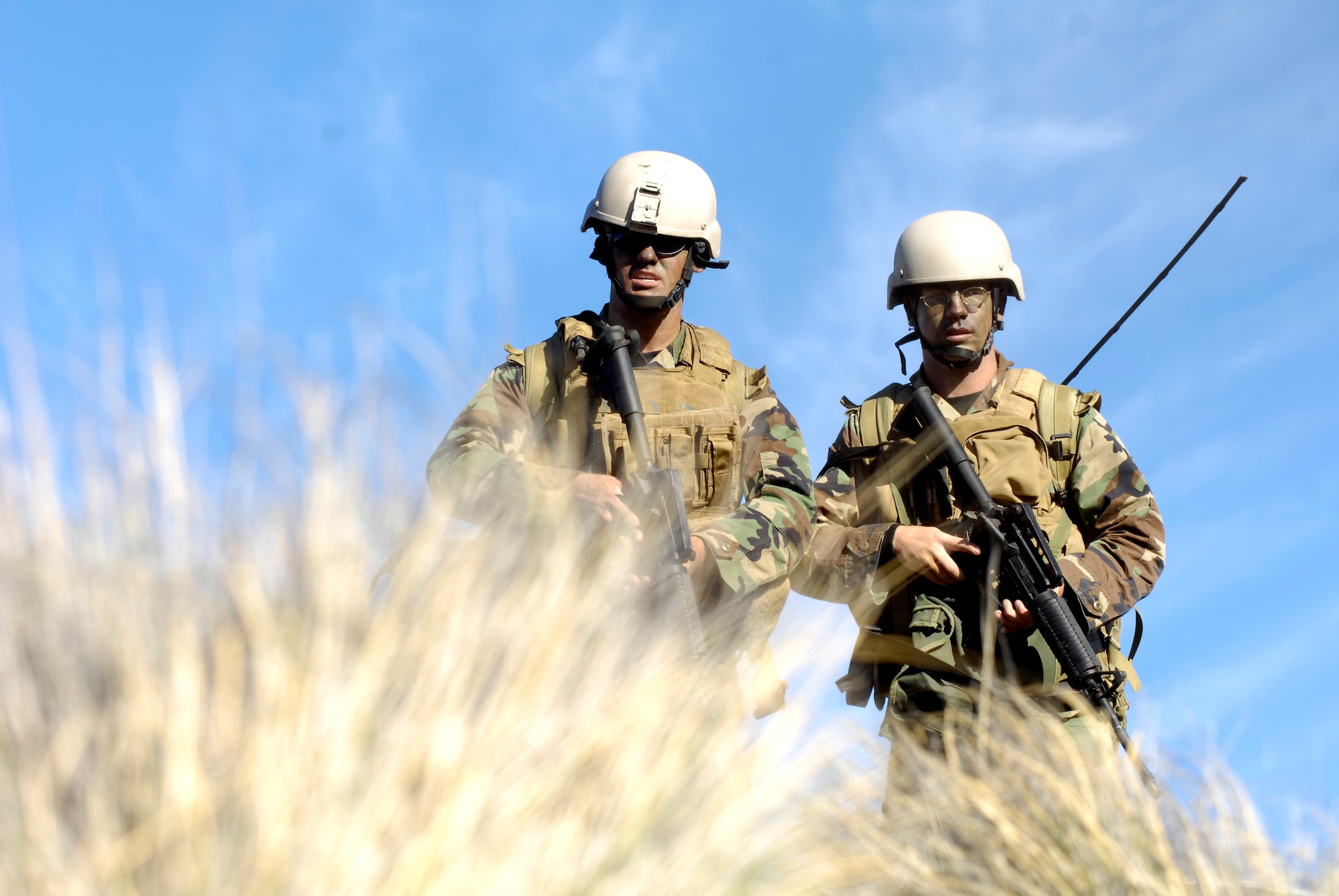 Airman 1st Class Robert Gaines and Airman Kyle Zamudio practice patrolling and clearing an area Oct. 23, 2007 at the Pohakuloa Training Area on the big island of Hawaii. The Airmen are tactical air control party members from the 25th Air Support Operations Squadron, Wheeler Army Airfield, Hawaii. The TACPs are training as part of the Koa Lighting exercise where bombers fly from Guam and practice their targeting.  Currently four B-2 Spirit bombers are at Andersen Air Force Base, Guam, as part of the Continuous Bomber Presence mission.  Rotational bomber deployments to Guam help maintain stability and security in the region while allowing stateside-based units to become familiar with operating in the Pacific theater.  (U.S. Air Force photo/Tech. Sgt. Shane A. Cuomo)


