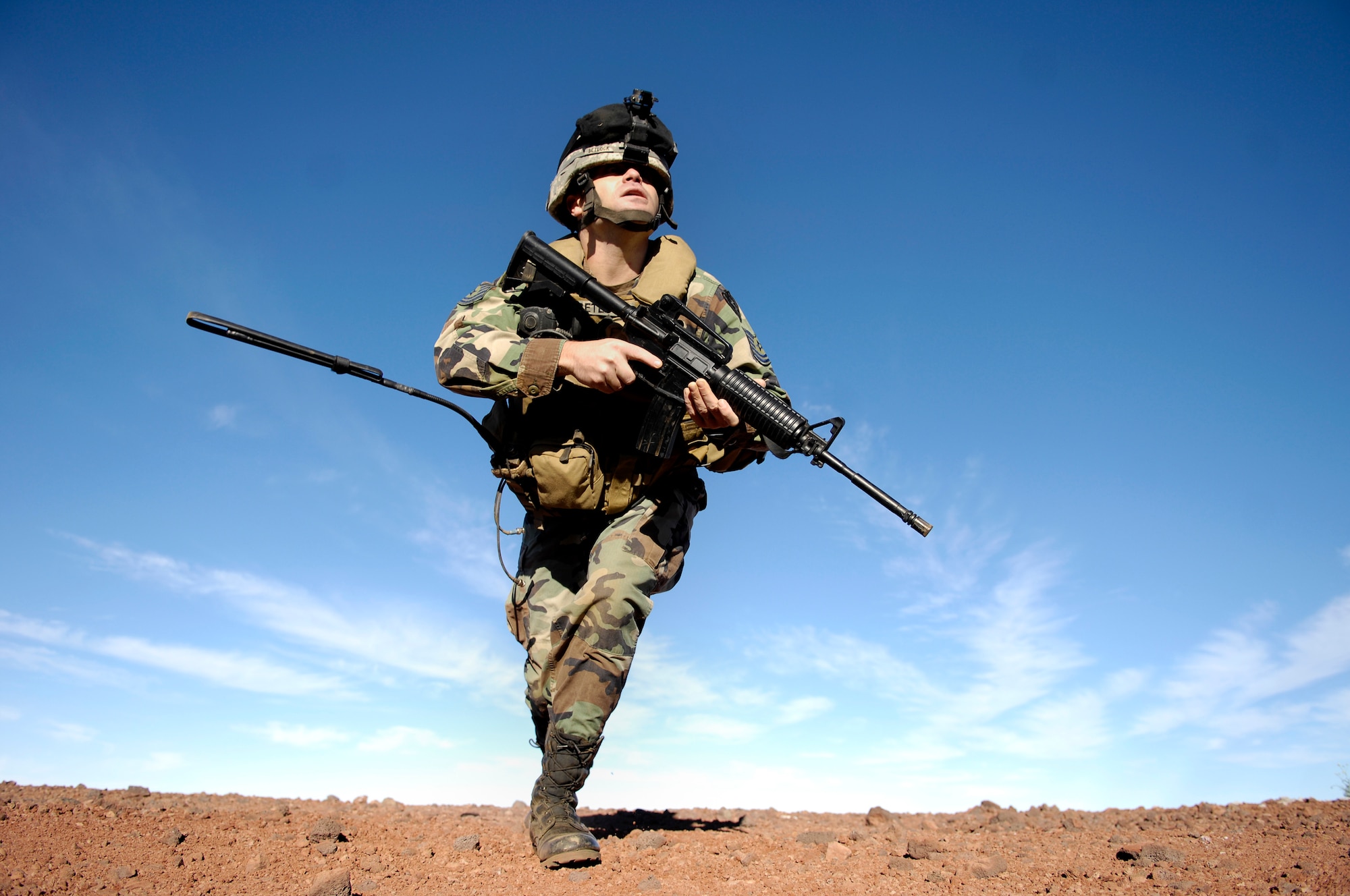 Tech. Sgt. Rick Setlock bounds to another firing position during training Oct. 23, 2007 at the Pohakuloa Training Area on the big island of Hawaii. TSgt. Setlock is a tactical air control party member from the 25th Air Support Operations Squadron, Wheeler Army Airfield, Hawaii. The TACPs are training as part of the Koa Lighting exercise where bombers fly from Guam and practice their targeting.  Currently four B-2 Spirit bombers are at Andersen Air Force Base, Guam, as part of the Continuous Bomber Presence mission.  Rotational bomber deployments to Guam help maintain stability and security in the region while allowing stateside-based units to become familiar with operating in the Pacific theater.   (U.S. Air Force photo/Tech. Sgt. Shane A. Cuomo)