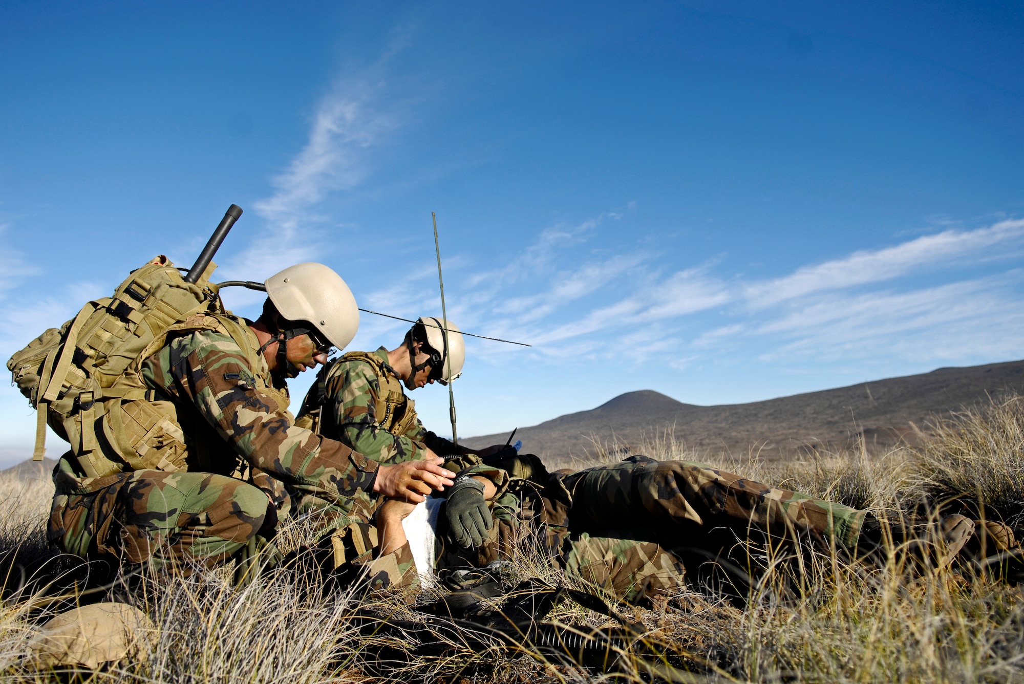 Airman Kyle Zamudio and Airman 1st Class Robert Gaines practice advanced self-aid buddy care and calling in medical evacuation Oct. 23, 2007 at the Pohakuloa Training Area on the big island of Hawaii. The Airmen are tactical air control party members from the 25th Air Support Operations Squadron, Wheeler Army Airfield, Hawaii. The TACPs are training as part of the Koa Lighting exercise where bombers fly from Guam and practice their targeting. Currently four B-2 Spirit bombers are at Andersen Air Force Base, Guam, as part of the Continuous Bomber Presence mission.  Rotational bomber deployments to Guam help maintain stability and security in the region while allowing stateside-based units to become familiar with operating in the Pacific theater.  (U.S. Air Force photo/Tech. Sgt. Shane A. Cuomo)