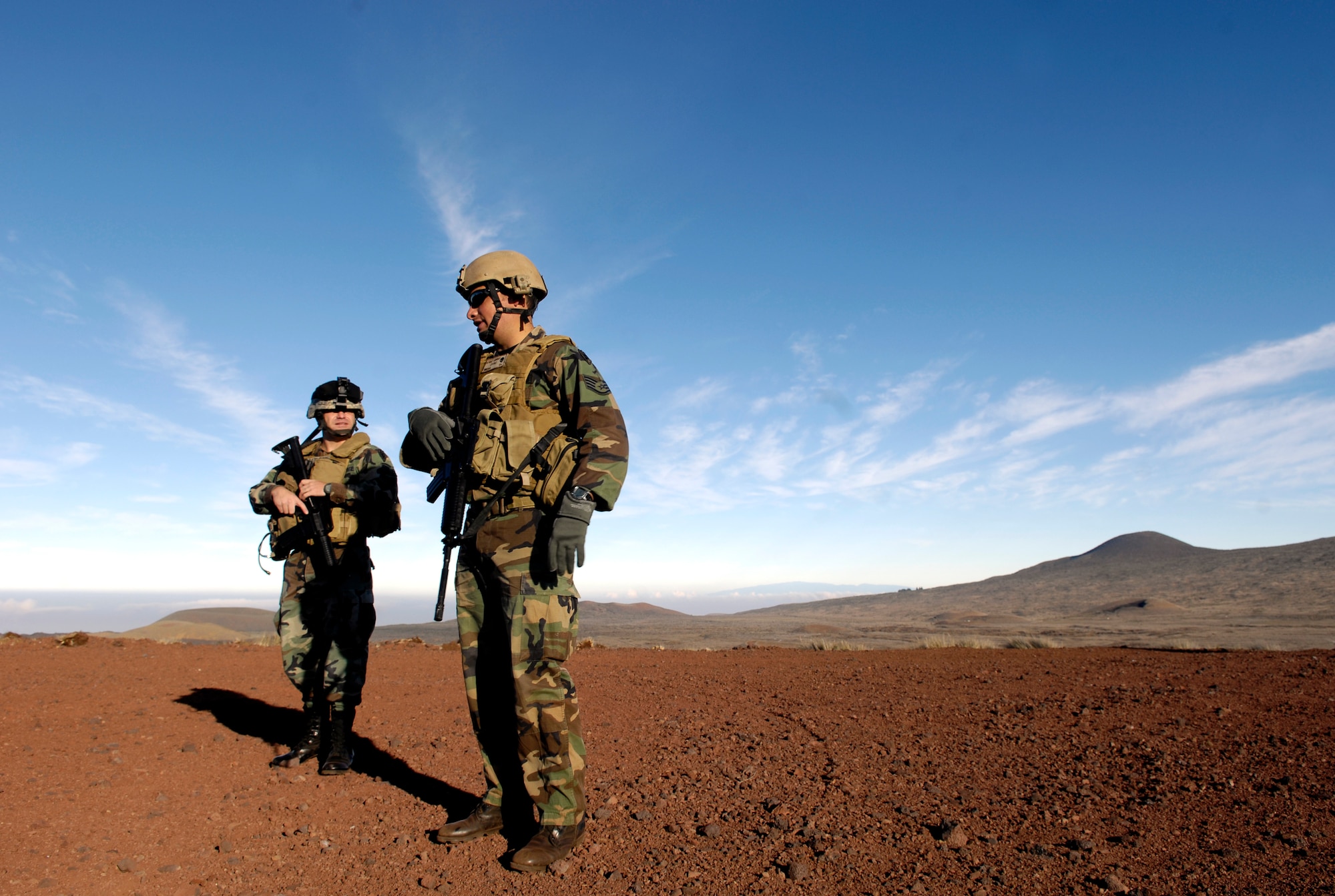 Tech. Sgt. Rick Setlock and Staff Sgt. George Earhart wait to begin training Oct. 23, 2007 at the Pohakuloa Training Area on the big island of Hawaii. The Airmen are tactical air control party members from the 25th Air Support Operations Squadron, Wheeler Army Airfield, Hawaii. The TACPs are training as part of the Koa Lighting exercise where bombers fly from Guam and practice their targeting.  Currently four B-2 Spirit bombers are at Andersen Air Force Base, Guam, as part of the Continuous Bomber Presence mission.  Rotational bomber deployments to Guam help maintain stability and security in the region while allowing stateside-based units to become familiar with operating in the Pacific theater.  (U.S. Air Force photo/Tech. Sgt. Shane A. Cuomo)